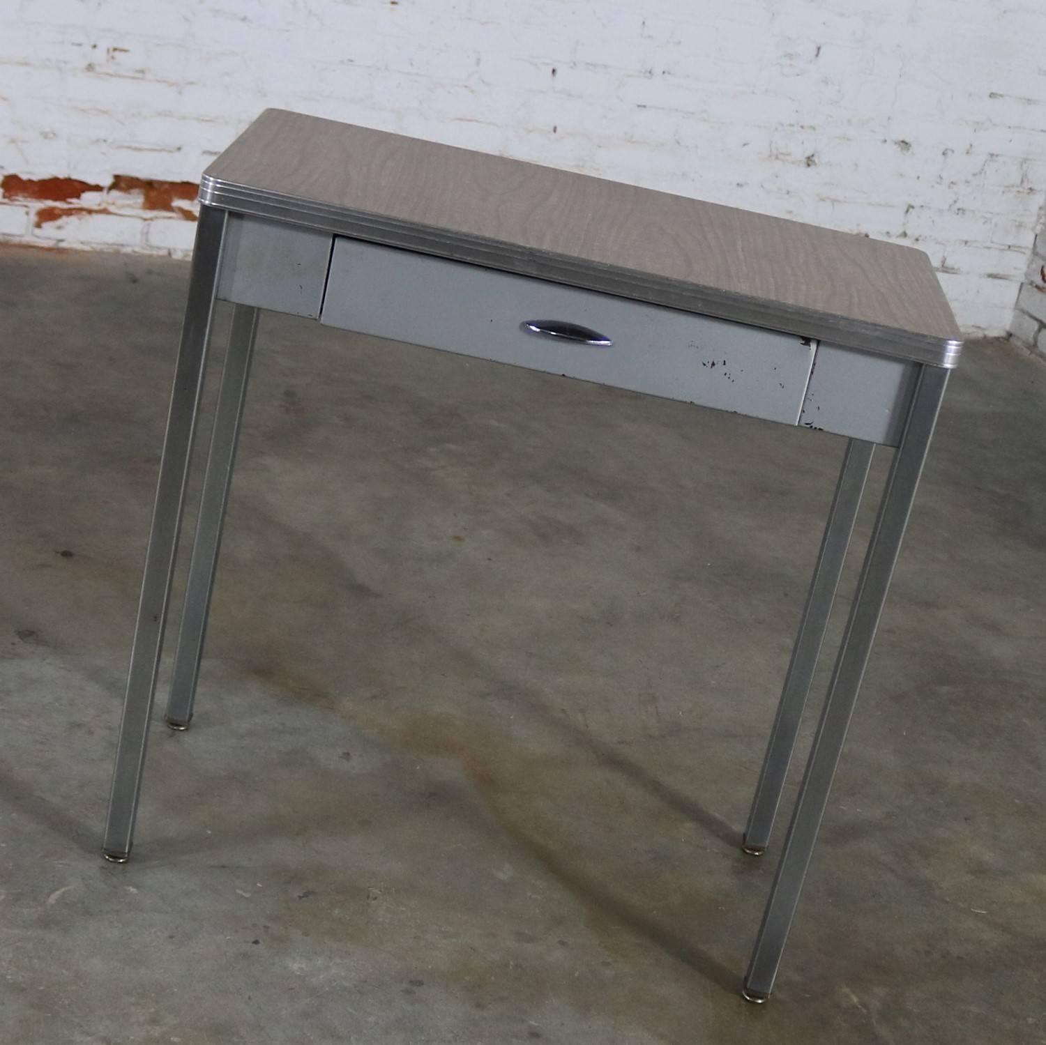 Handsome Art Deco, Machine Age, streamline moderne, or art moderne hall table or small desk by Royal Metal Manufacturing. This piece is in wonderful vintage condition but not without normal nicks and dings you would expect for its age to the