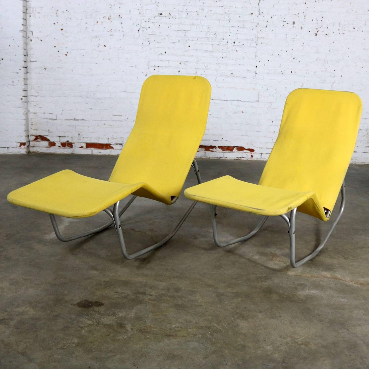 Exceptional pair of Barwa lounge chairs designed by Edgar Bartolucci and John Waldheim. Made of aluminium extruded tube with a yellow canvas sling. The aluminium is weathered from being outside for their lifetime as they were intended, and the