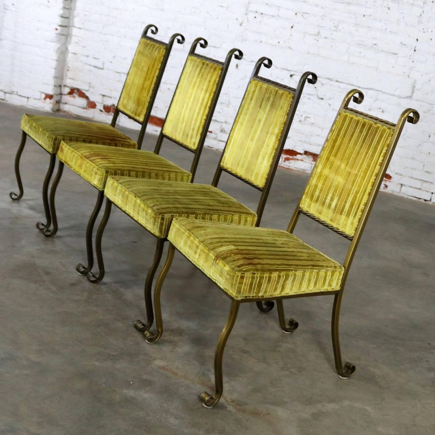 Handsome set of four wrought iron and upholstered dining chairs in a Hollywood Regency styling by Swirl Craft of Sun Valley, California. This set is in very good vintage condition with their original finish and upholstery. However, there are several