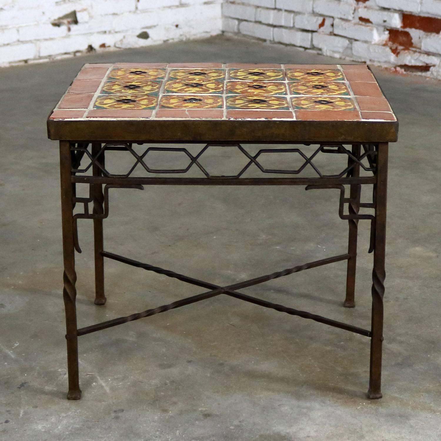 Fabulously beautiful Art Deco wrought iron frame table with a tile top in the style of one of the California potteries or tile makers. This table is in fabulous condition apart from some small spots of missing grout and one of the frame tiles has a