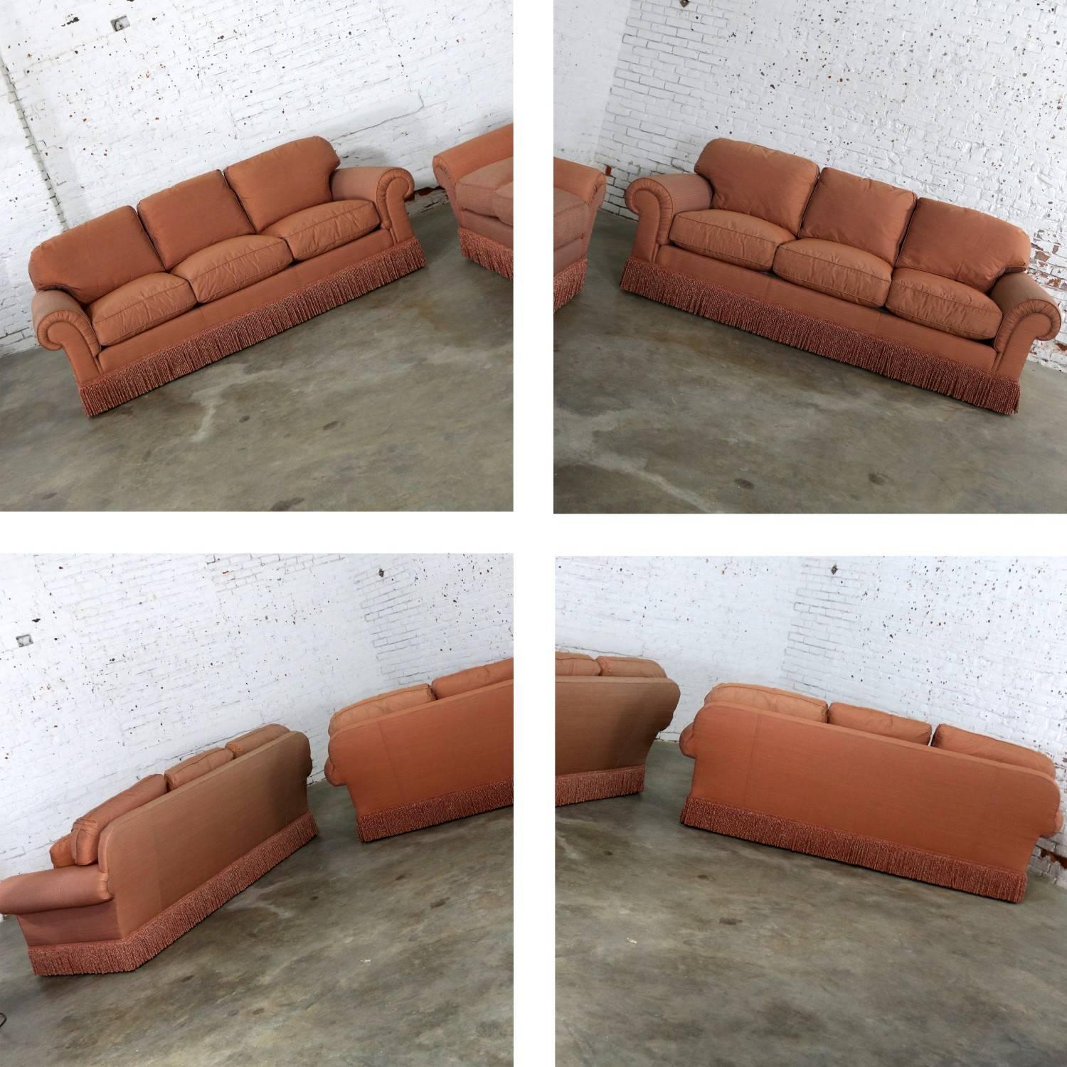 Beautiful Baker Furniture Lawson style sofas from their Crown and Tulip collection in a gorgeous terracotta / peach / coral colored ribbed tight weave taffeta-like heavy upholstery fabric with bouillon fringe and poly / feather / down pillows and