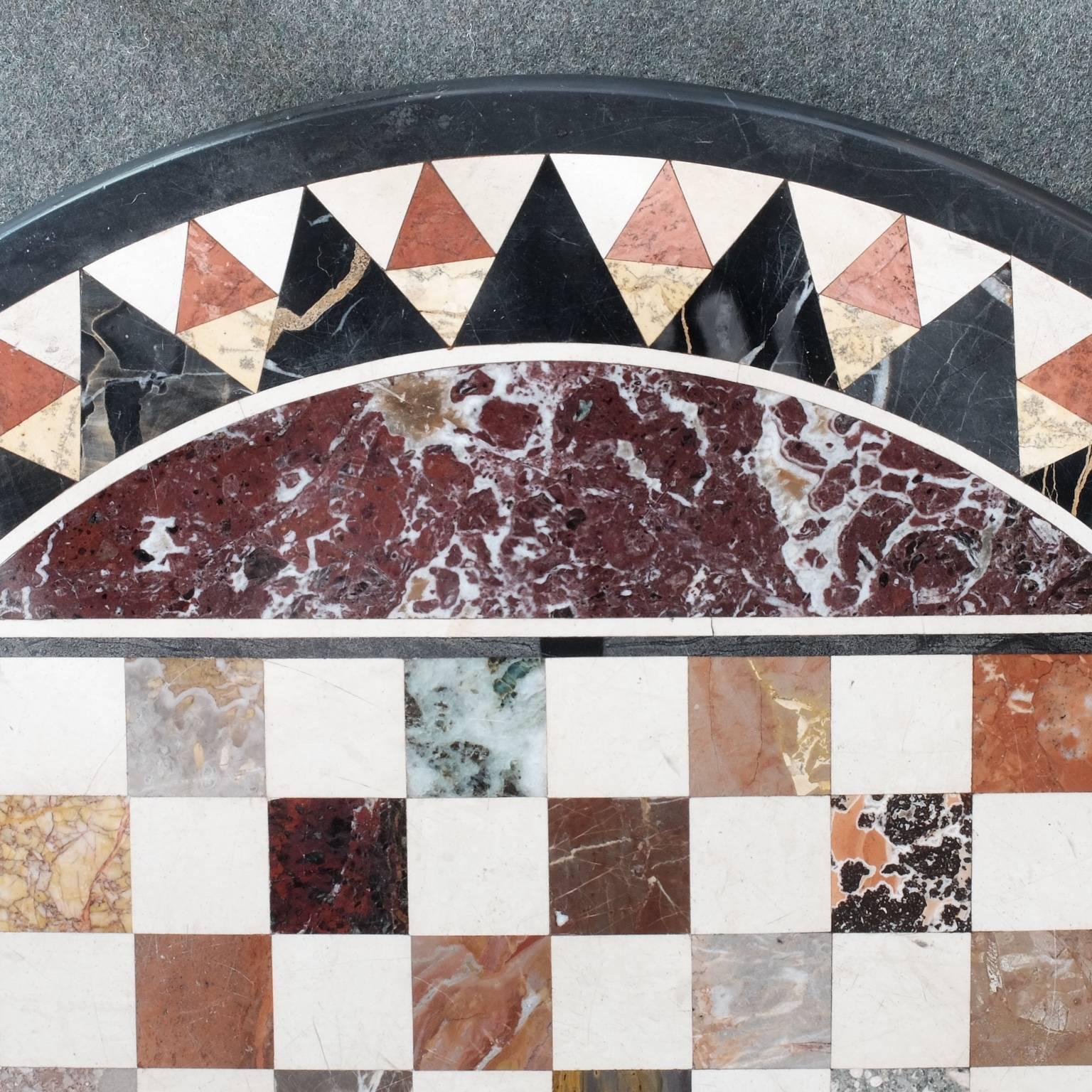 An early 19th century circular tabletop composed of many different colored specimen marbles inlaid into a base of 'black marble'. The black marble base is actually a type of limestone almost exclusively quarried in Derbyshire, England (Ashford black