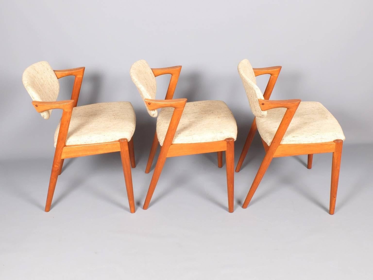 A set of six teak dining chairs designed by Kai Kristiansen in the 1960s and manufactured by V Schou Andersen. Also known as the 'Z' chair they feature a tilting back which makes them very comfortable. The teak frames are in very good condition and
