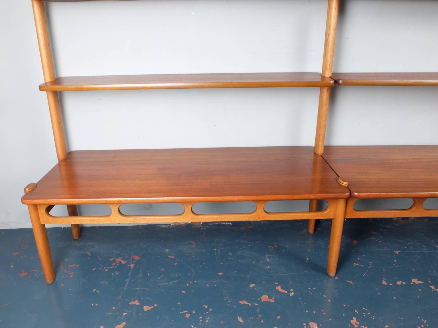 Designed by American born William Watting and produced by Mikael Laursen
this is the model 85 wall shelving unit. This Danish 1960s piece consists of ten teak shelves supported by three oak uprights and an oak under-frame. The shelves themselves