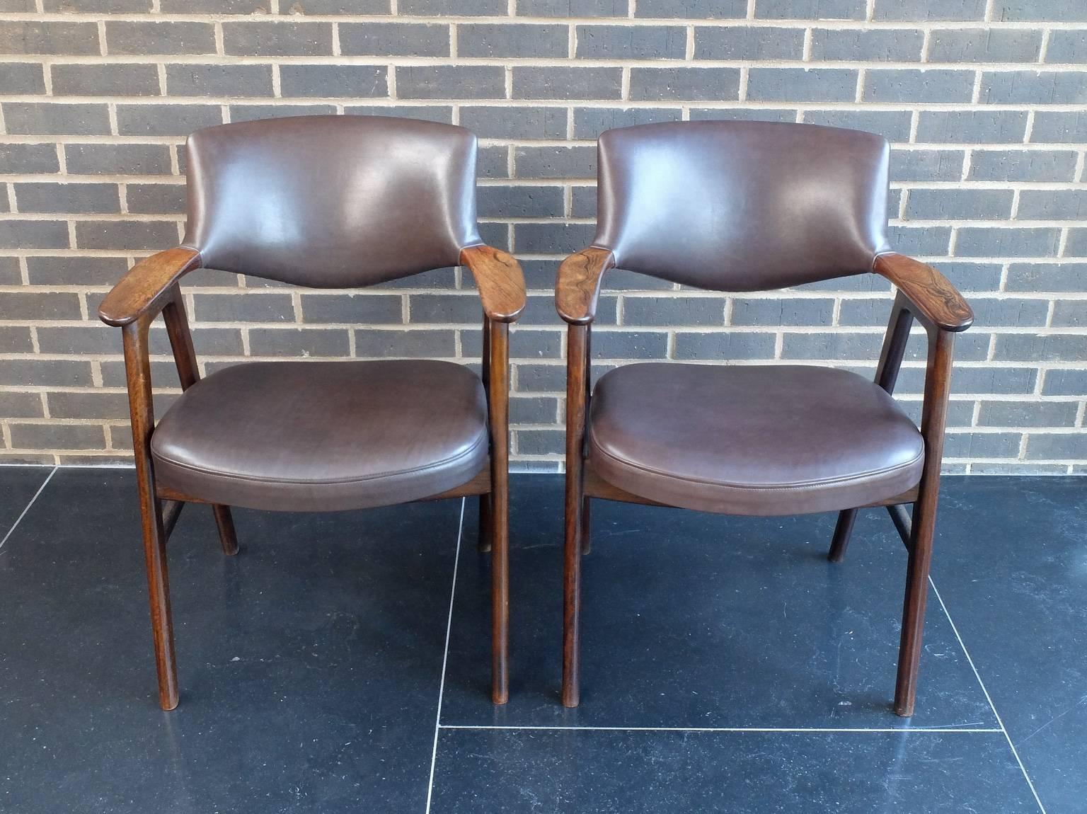 A pair of armchairs designed by Erik Kirkegaard and produced by Hong Stolefabrik in the 1950s. The chair arms are made from well figured Brazilian rosewood and the rest of the frames from mahogany. They have been fully re-upholstered in a top