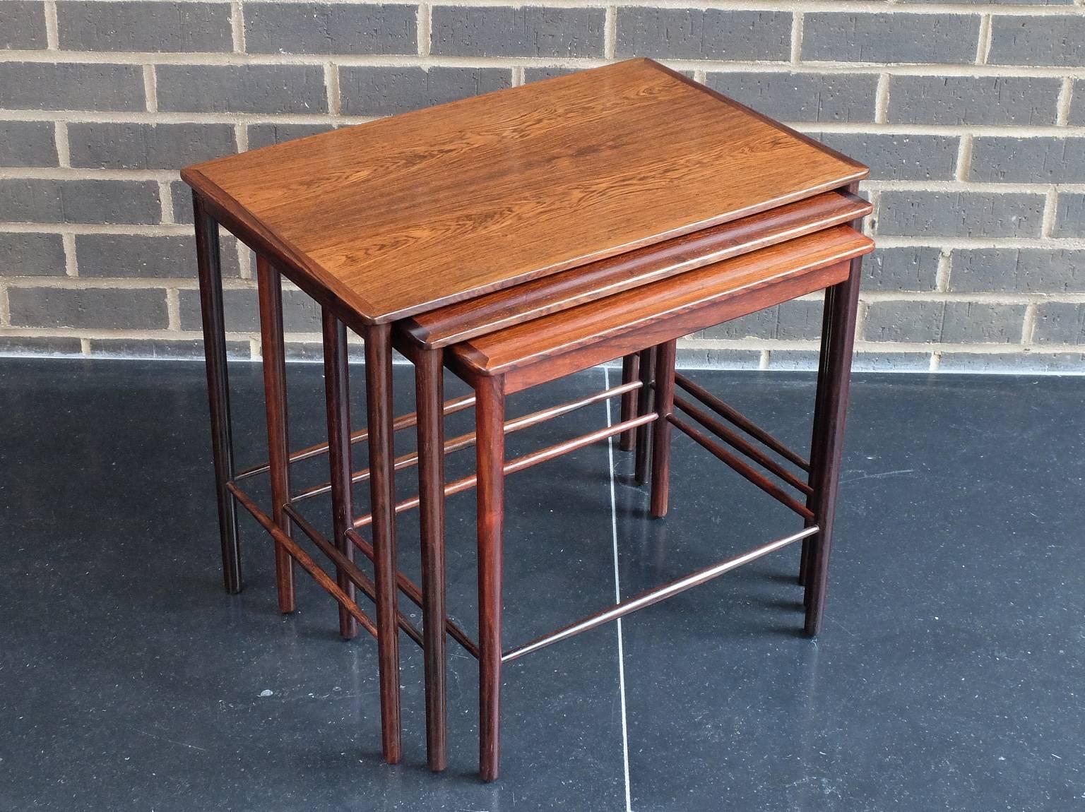 A nest of three occasional tables designed by revered designer Kai Winding and manufactured by Poul Jeppesen, Denmark, circa 1960. These elegant tables are beautifully crafted from Brazilian rosewood. Please note that there are differences in colour