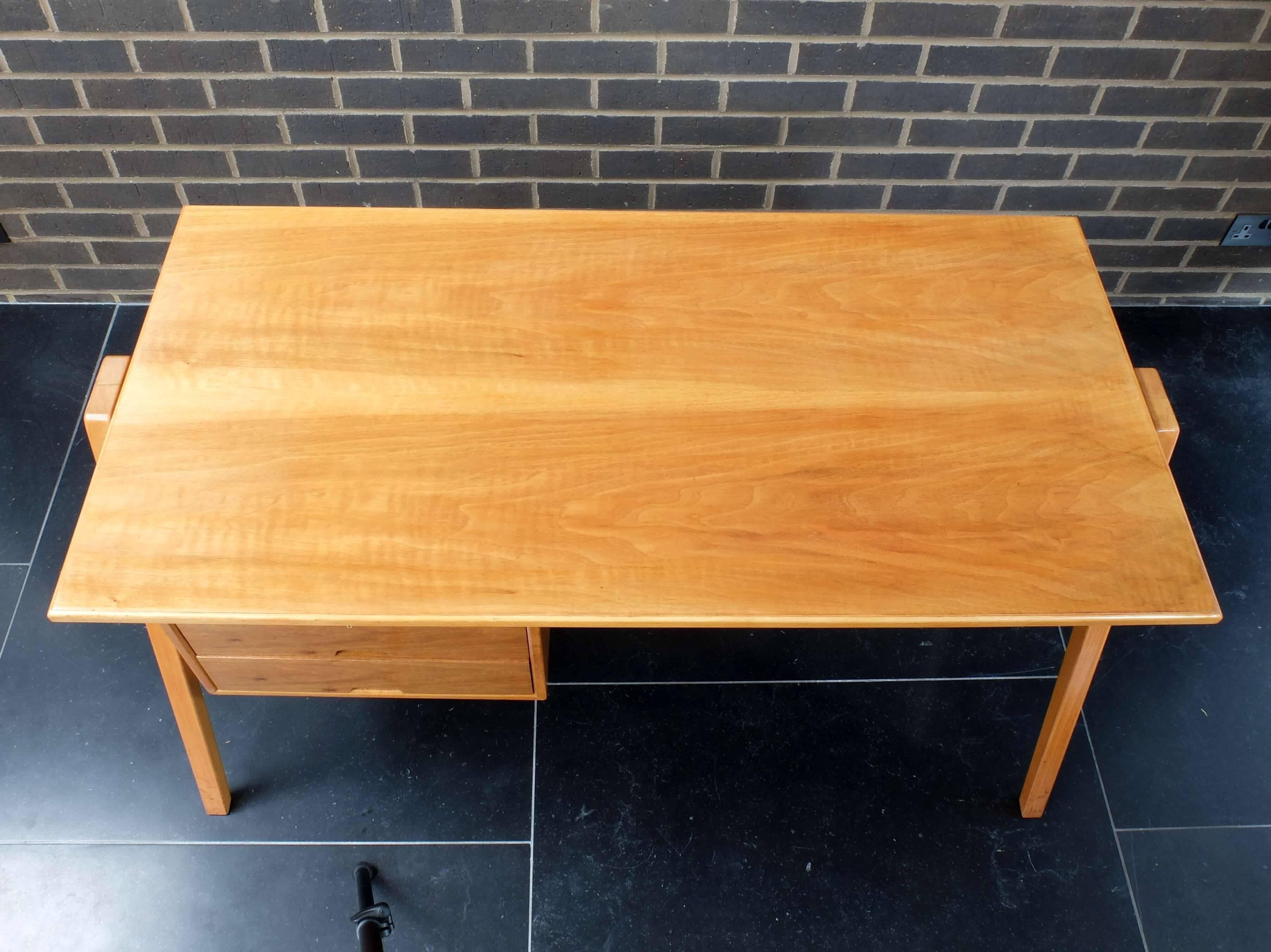 Designed in 1950 by iconic British post-war designer Robin Day we can offer this very rare desk and matching chair. The desk is made of beech with drawer fronts of Nigerian cherry and is in excellent condition having been in the same family from