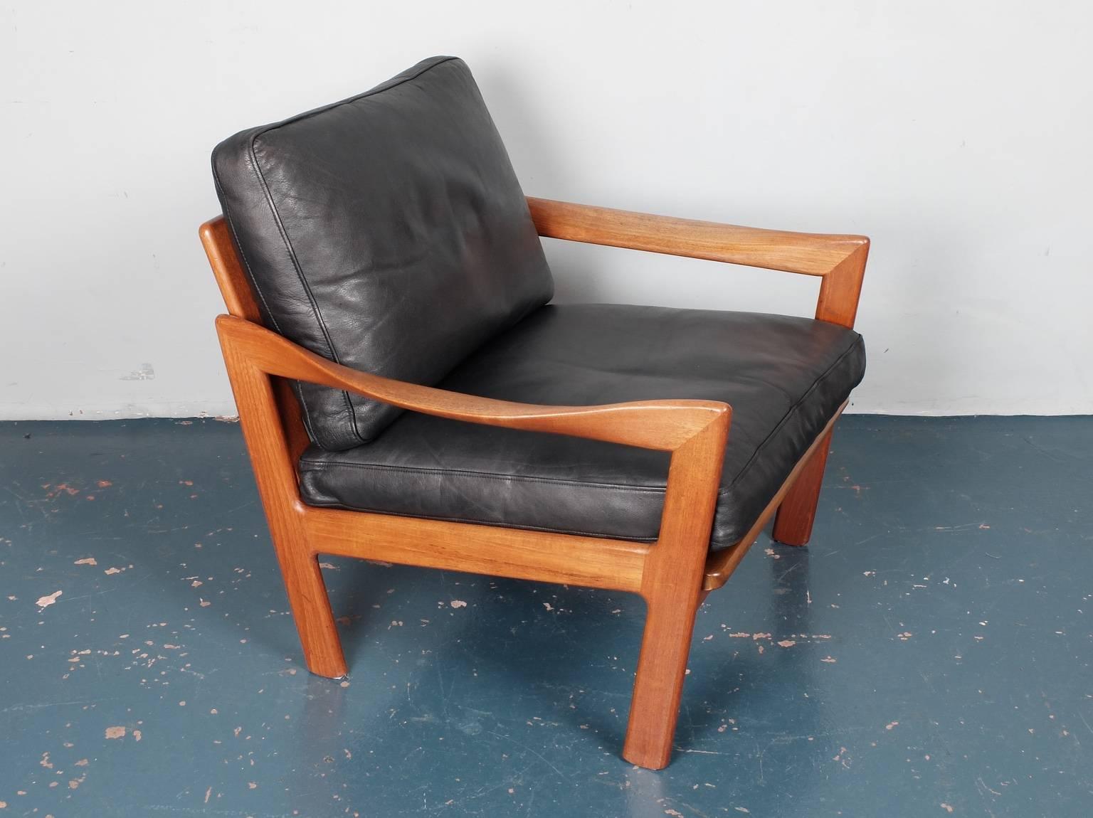 A teak framed armchair designed by Illum Wikkelsø and produced by Eilersen, Denmark, circa 1960. We have 4 of these armchairs available at the moment that can be upholstered in your choice of fabric. As well as the wonderfully sculptural arms this