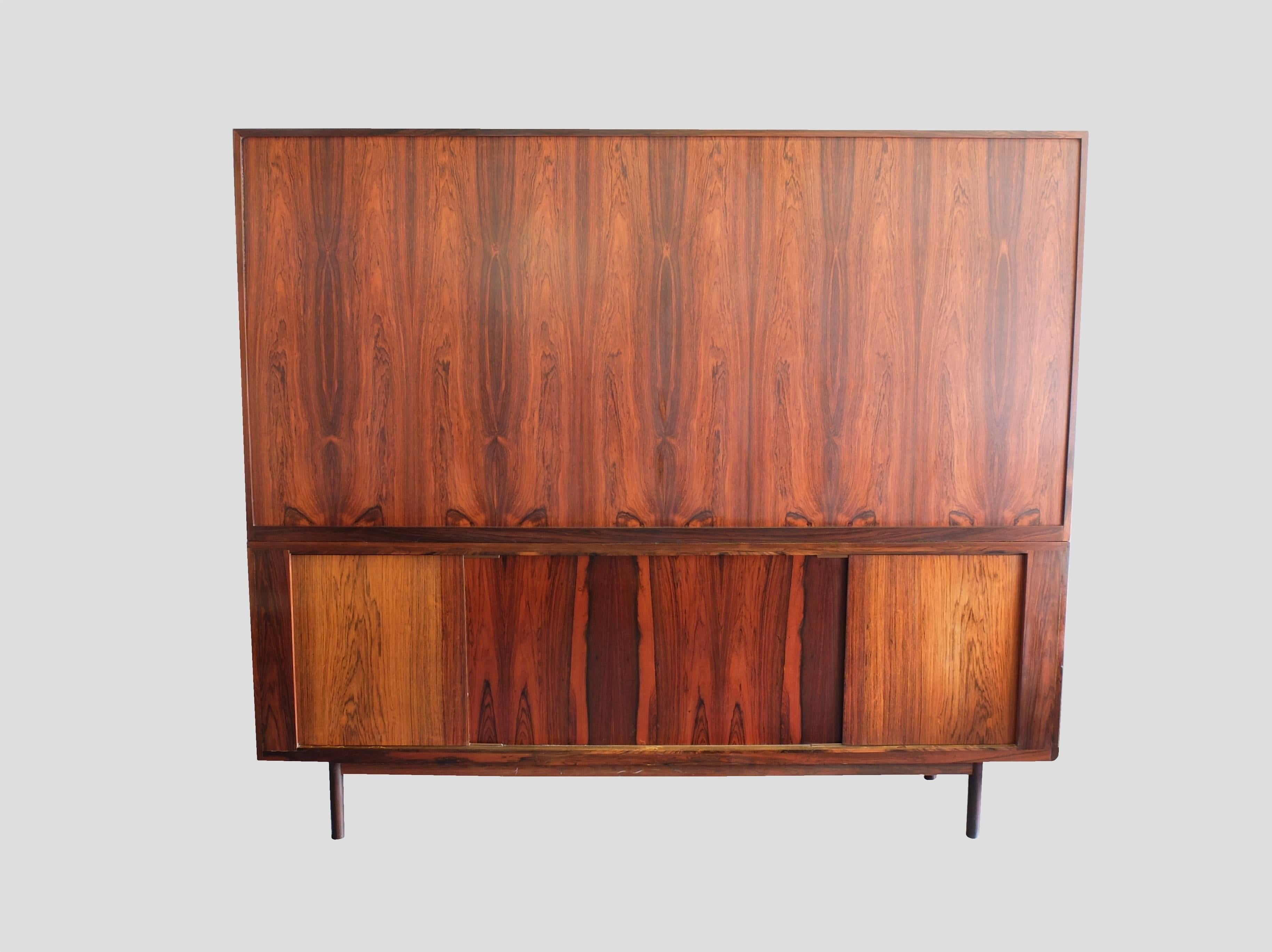 Designed by Ib Kofod Larsen and featuring beautifully grained Brazilian Rosewood throughout. This sideboard has two tambour doors of the highest quality, the individual sections only visible under close inspection. Even the back is finished in the