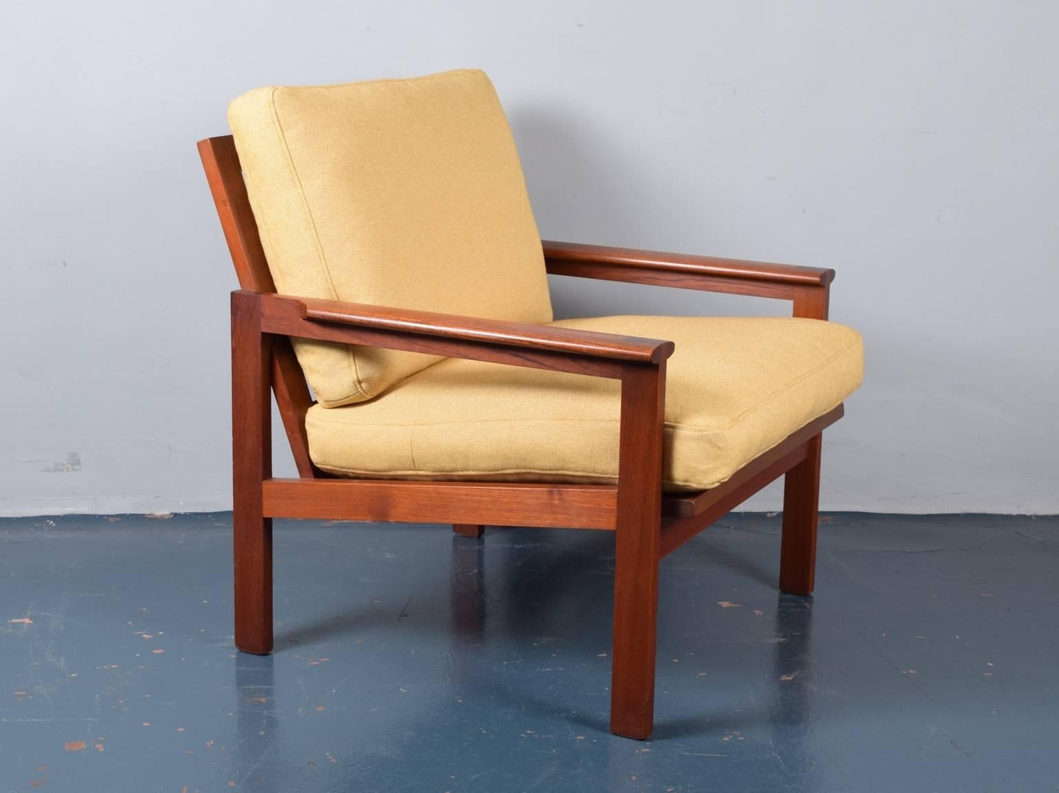 A teak framed armchair designed by Illum Wikkelso and produced by Eilersen, Denmark, circa 1960. This version of the 'Capella' armchair has open sides (we also have a rosewood version available with closed sides). The chair has been completely