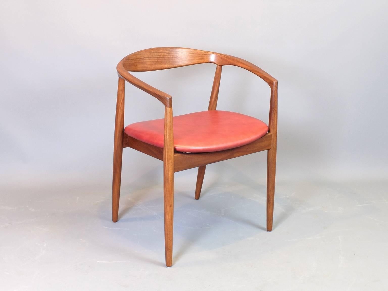 A single teak armchair designed by Kai Kristiansen and manufactured by Magnus Olesen in Denmark in the 1960s. The arms of this curved, round back chair bear similarities to the Paper Knife chair also by Kai Kristiansen. This model is the Troja and