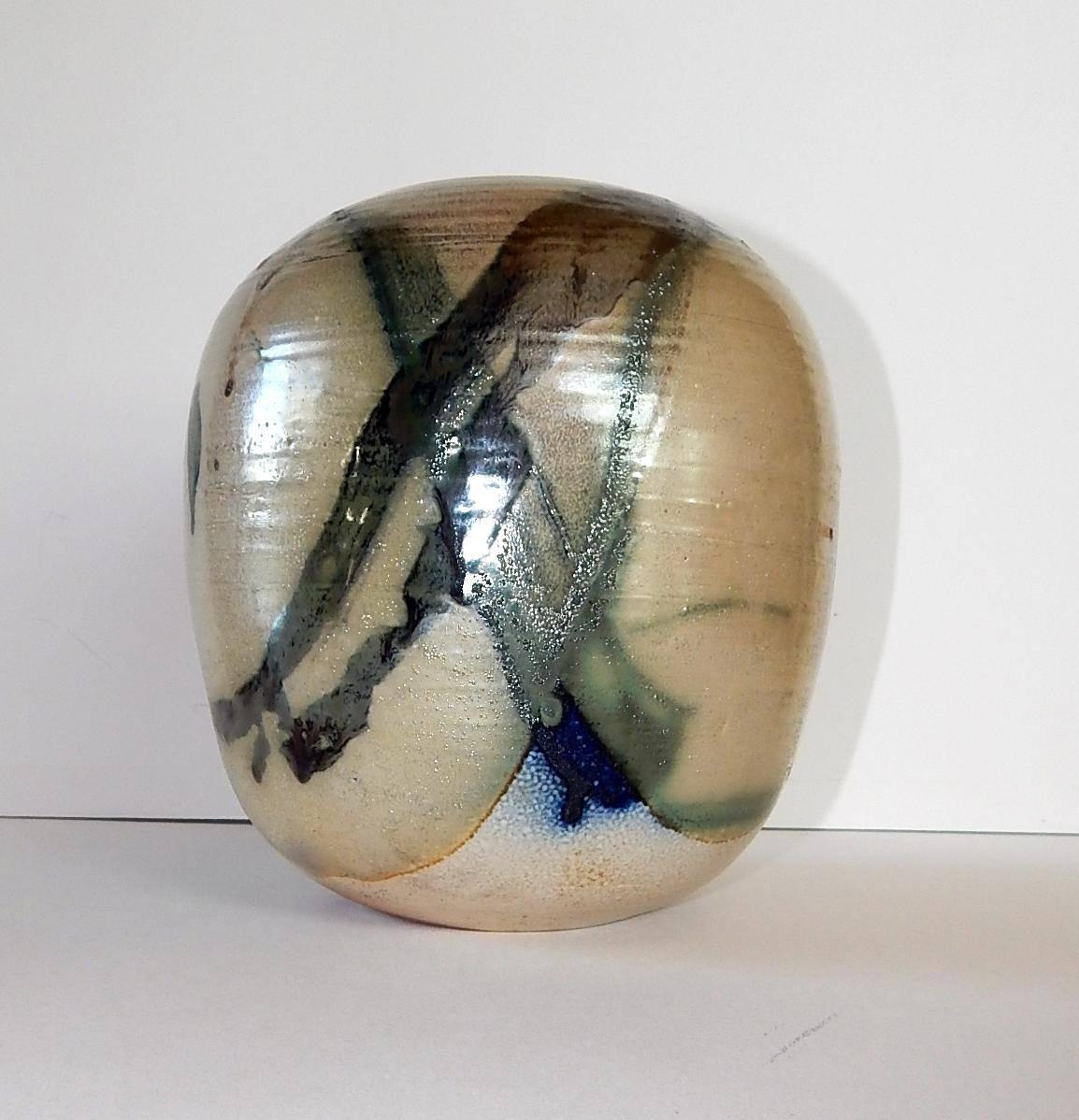 Colorful abstract moon pot design with rattle.
Extraordinary glaze.
Signed on the base with her TT monogram.
Measures: 8 1/2 inches H x 7 inches D.

Toshiko Takaezu (1922-2011), a Japanese-American ceramist who helped elevate ceramics from the