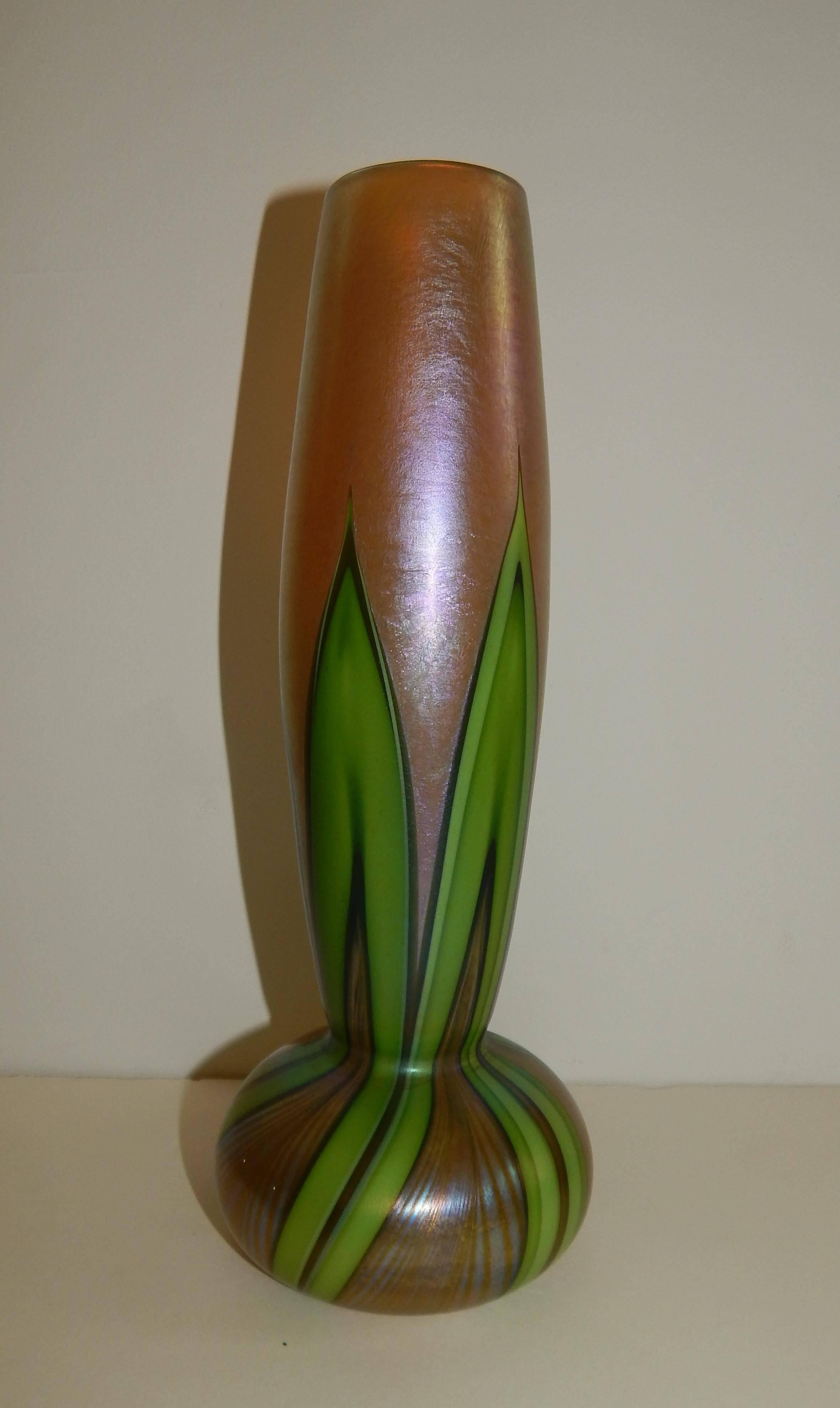 Iridized gold Favrile onion form vase from Tiffany Studios with green 
pulled feather design.

 Marked L.C. Tiffany, Favrile and 8041 H 
 Favrile glass was patented by Louis Comfort Tiffany in 1894.
This vase has great color and is in mint