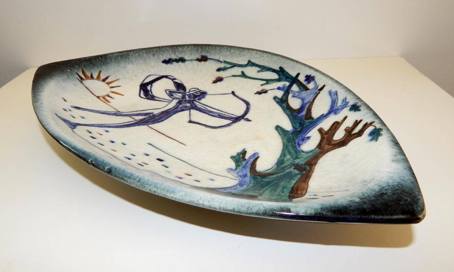 Beautiful ceramic tray depicting Diana the huntress.
Decorated by Alfonso Vila Shum (1897–1967)
Measures: 13 3/8 inches (length) x 9 inches (width).
Signed “SHUM” (faintly) lower right front and Stonelain pottery mark on the base with the