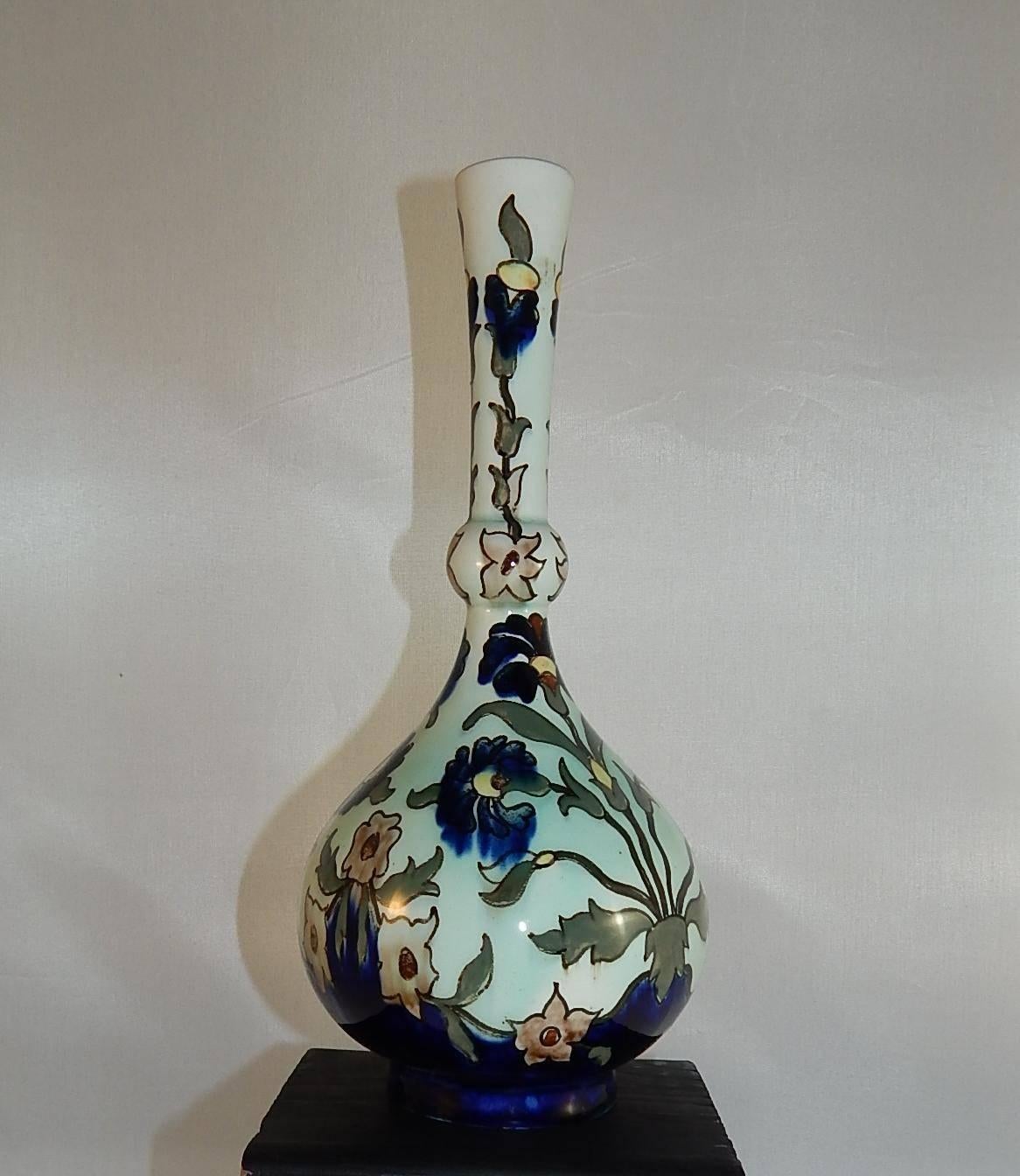 Rozenburg earthenware vase, Holland, circa 1890s.
Polychrome enameled with stylized flowers.
Painted mark: Rozenburg denHaag K522 and the stork symbol.
Measures: 8.63