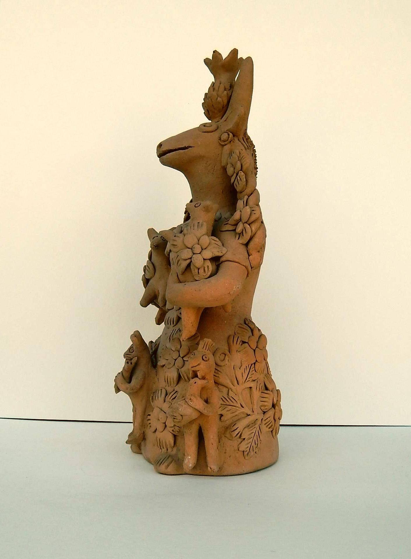 Oaxacan folk art piece in terracotta. 
Incised signature on the back: “T.B.”
This surreal animalistic mother figure is holding animal babies who in turn are holding smaller animals. 13 ½