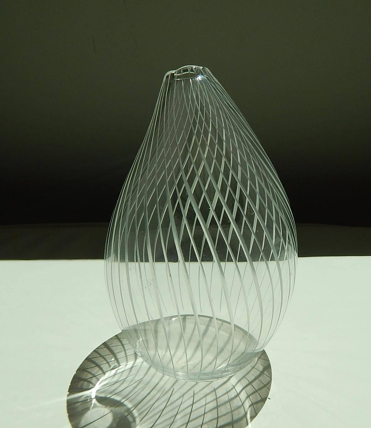 Tapio Wirkkala glass vase.
Organic shape in clear glass with incised lines.
Etched signature: Tapio Wirkkala, Iitala 
4 3/4