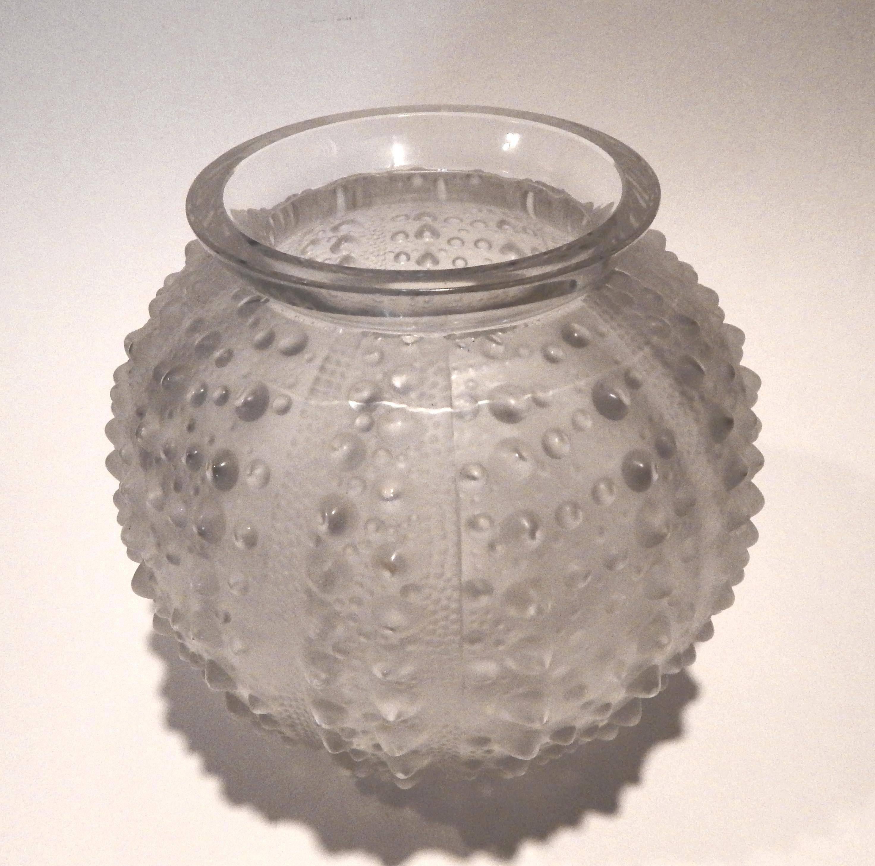This R. Lalique sea urchin vase is, circa 1935.
Frosted to clear with the surface reminiscent of the sea urchin.
Signed with etched signature 