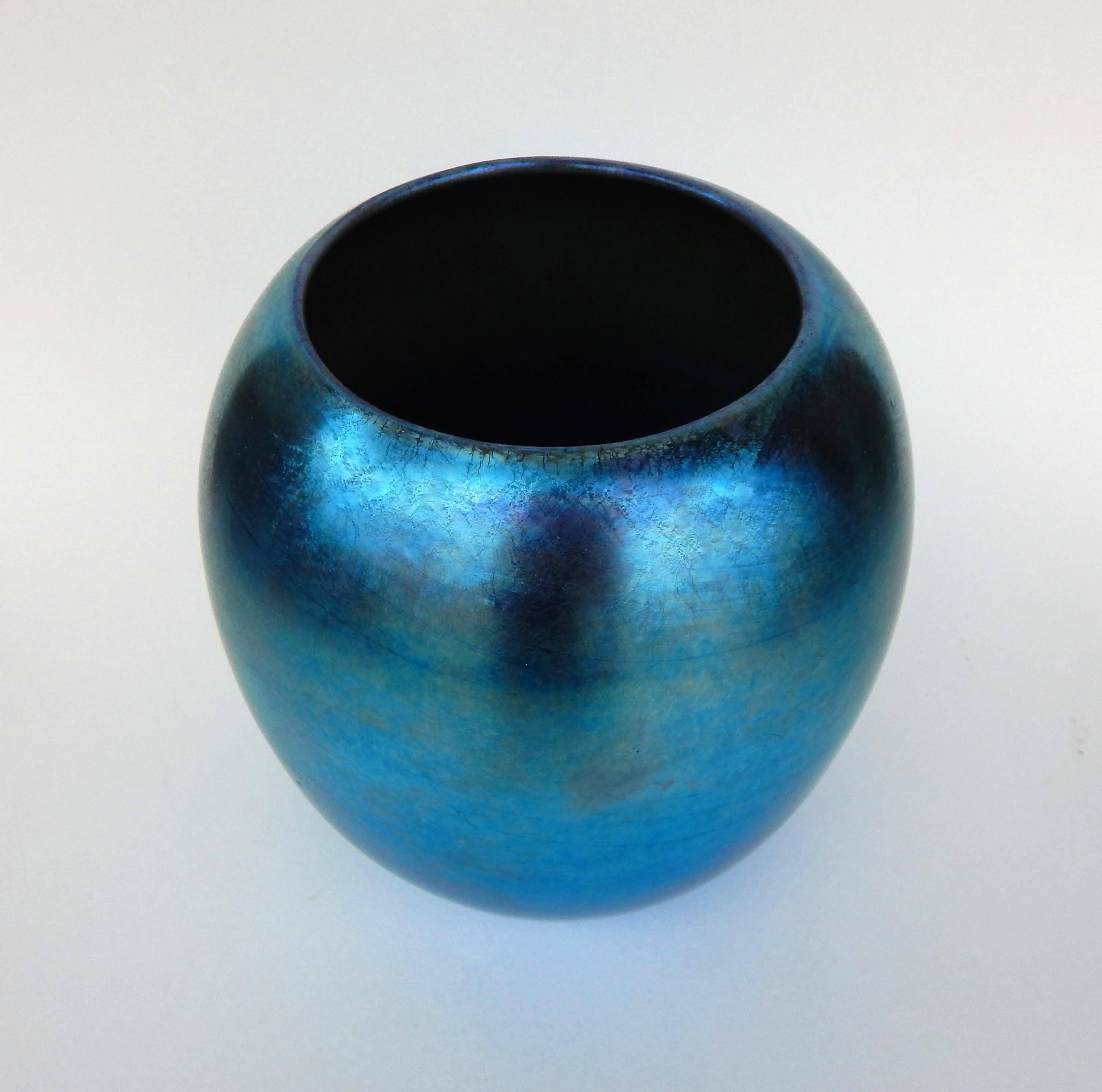 This luminous blue American art glass vase is signed 
on the bottom 