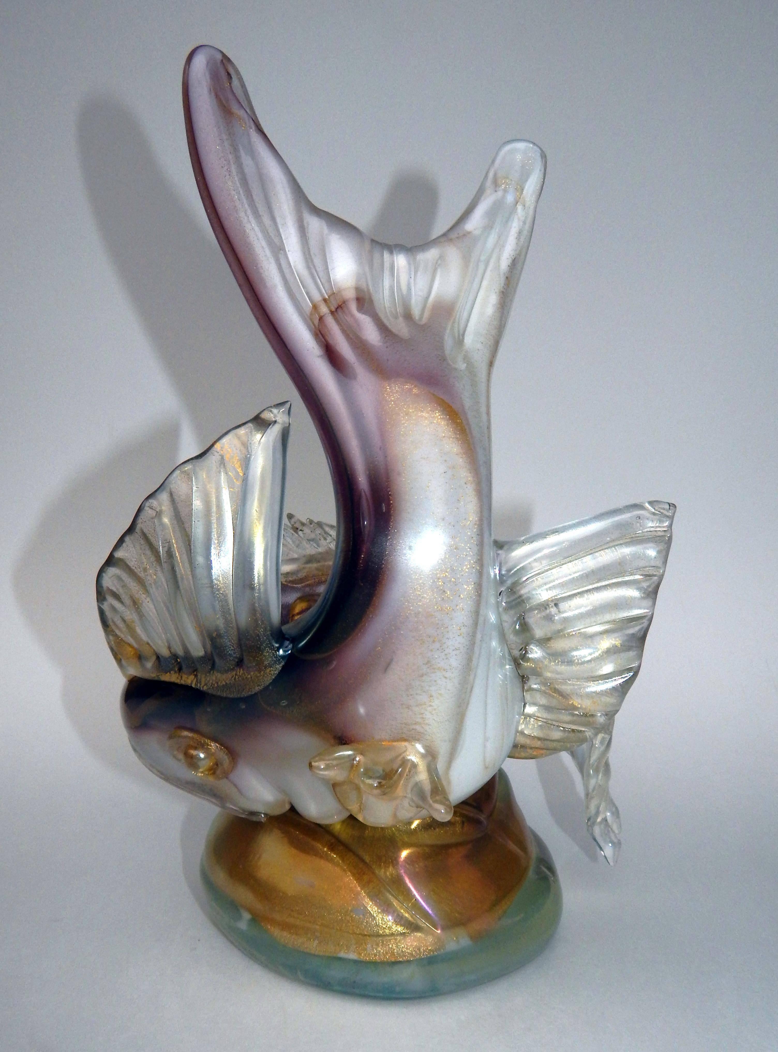 Large handblown double fish form on a single base with gold fleck throughout.
Pink, purple, blue and grey tones are seen. 
Created in the manner of Barbini and Seguso. 
Measures: 11 3/4