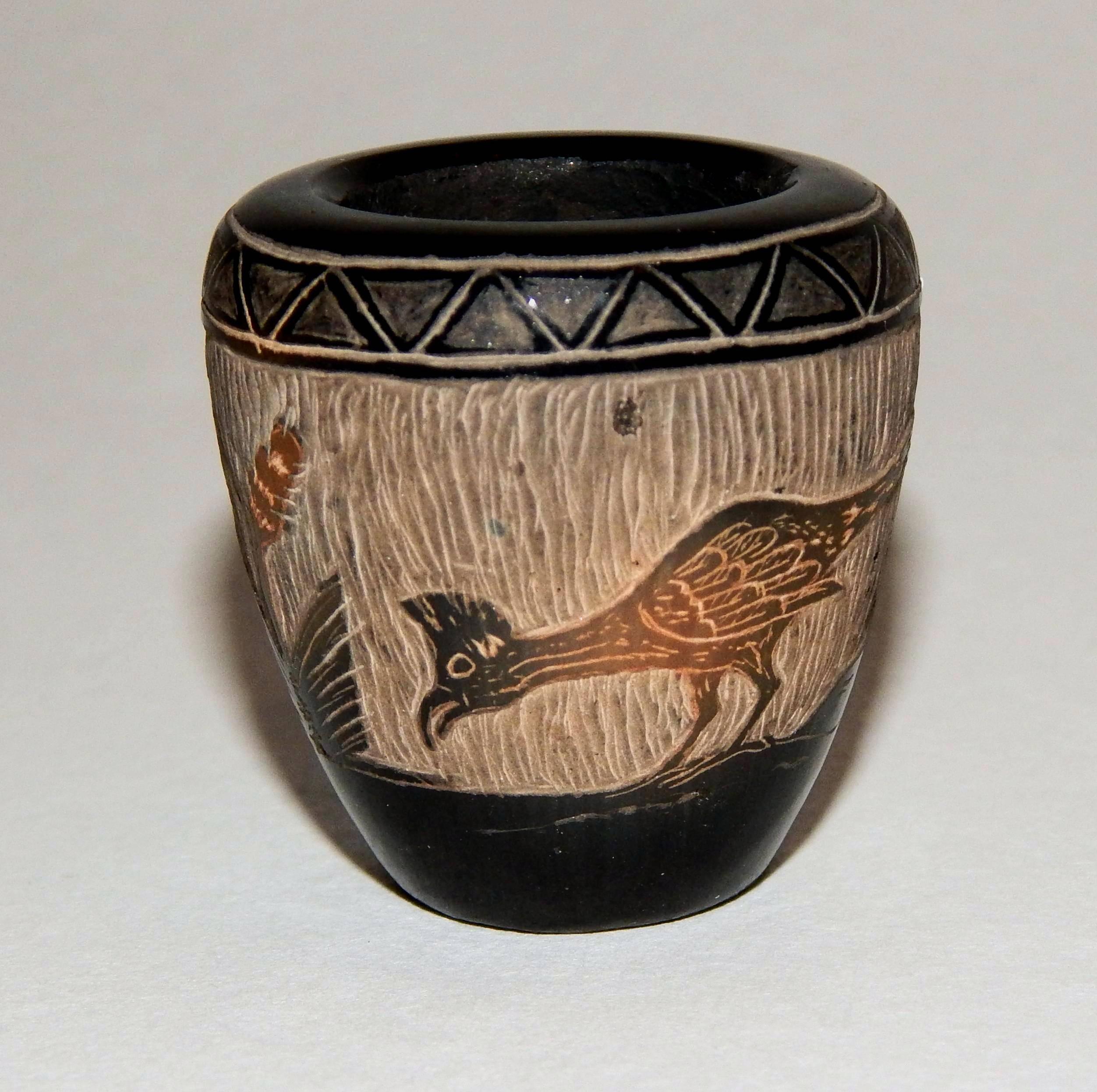 Corn Moquino miniature blackware vase with carved Roadrunner design. Signed on the bottom: Corn Moquino with his cornstalk emblem. Measures: 1.5