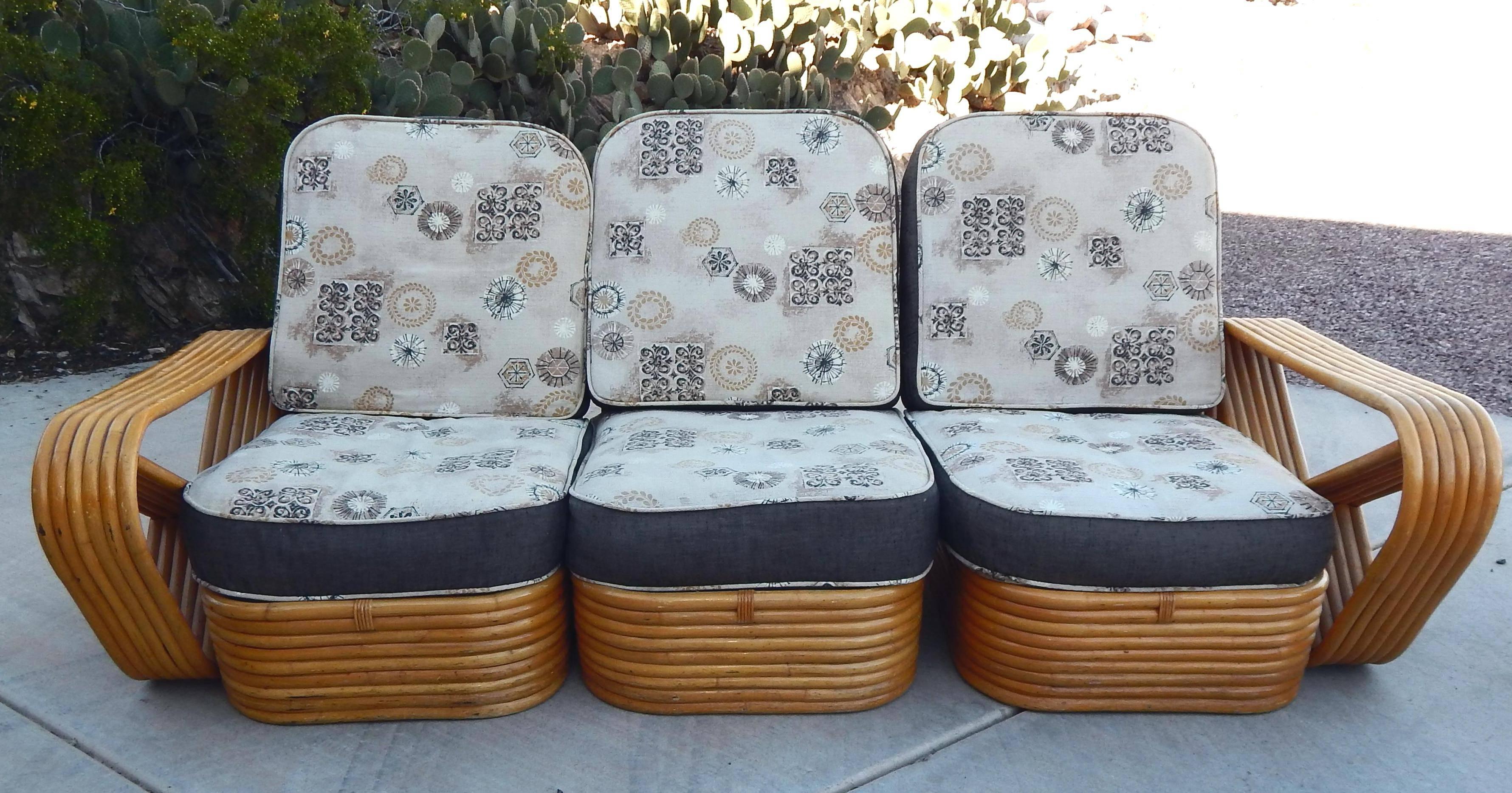 Paul Frankl style rattan living-room set including a sectional sofa, chair and ottoman. They feature six strand pretzel design side arms and stacked rattan base originally designed by Paul Frankl.

Origin: Japan.
Mid-Century Modern.
Rattan in
