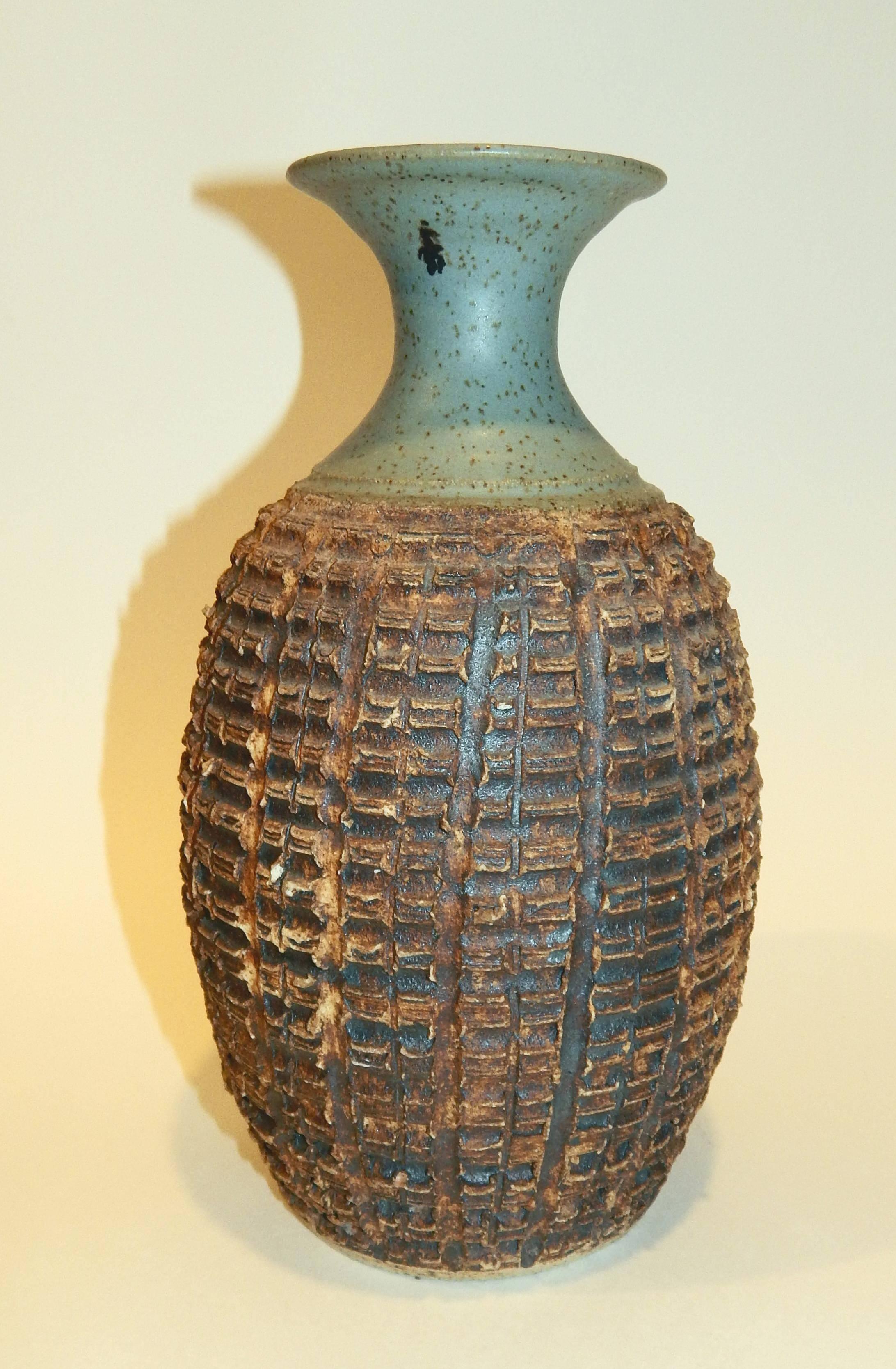 F. Carlton Ball (1911-1992) Studio ceramic vase.
Signed F.C. Ball, circa 1950's-1960's.
Deeply carved vase in rectangles with earthy brown glaze
at the lower part finishing with a Celadon glaze at the top.
Measures: 10 1/4