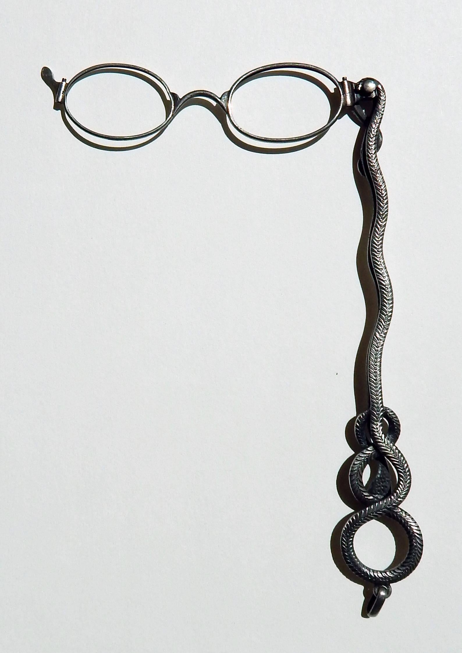 Spectacular .800 Silver folding lorgnette pendant with serpent design.
Faceted red stone or glass on the back of the serpent’s head.
Handle Measures: 7 inches long
Measures: 10 5/8