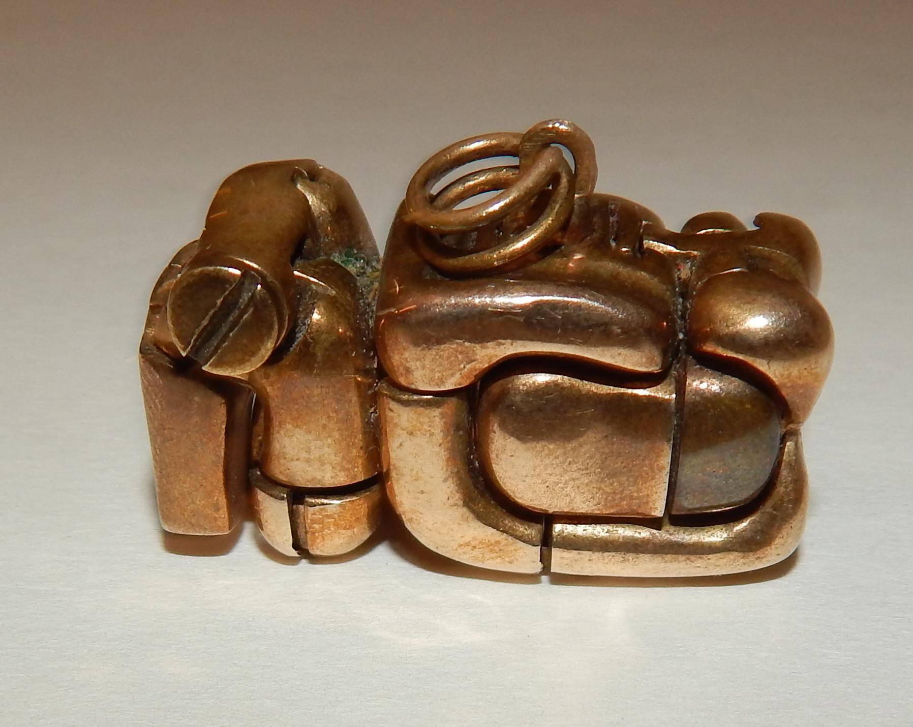 A bronze sculpture by Miguel Berrocal (1933-2006)
Created circa 1969-1970.
This bronze puzzle sculpture is made of 23 pieces and is accented with a small blue gemstone.
Measures: 1 1/4