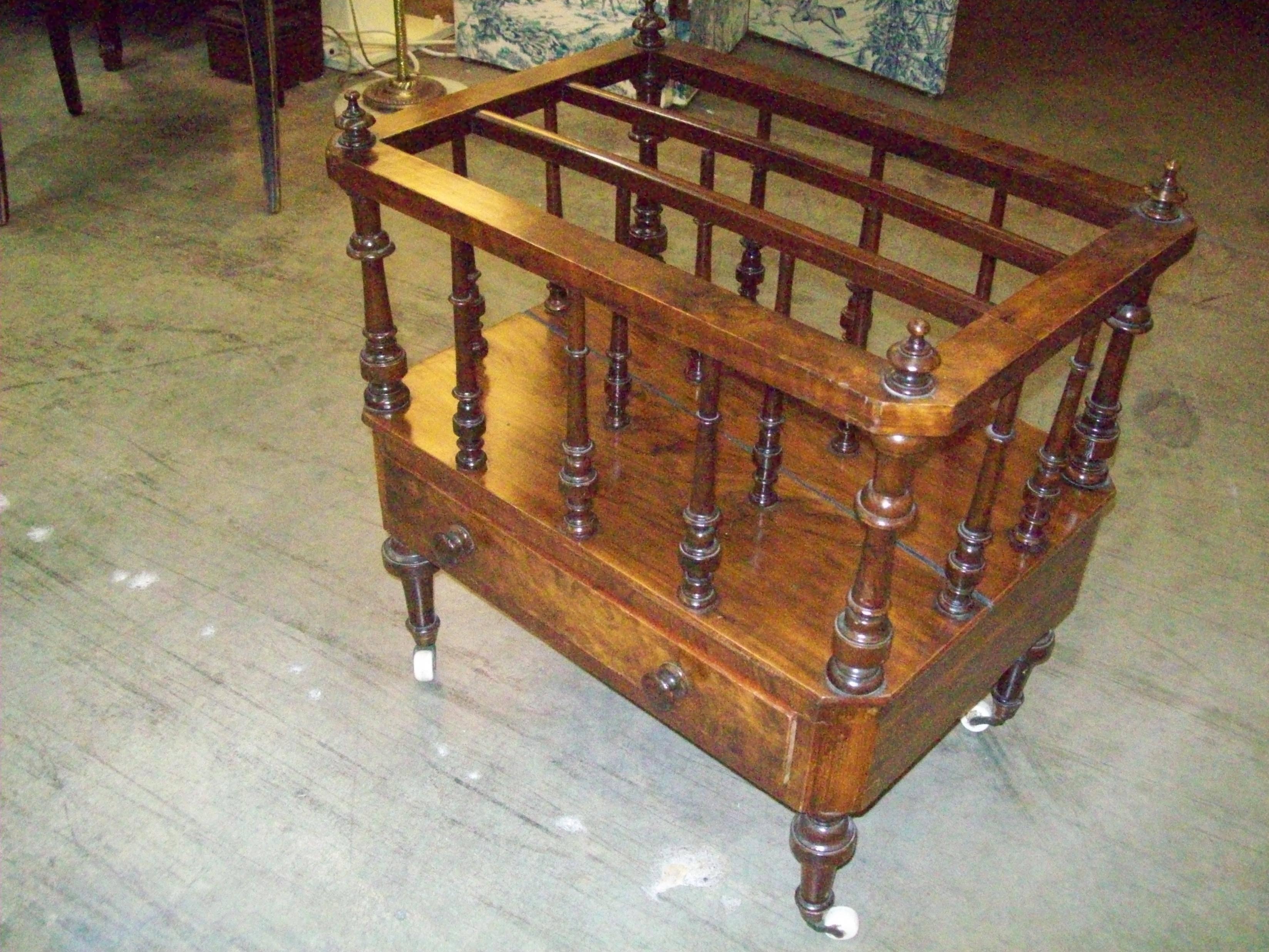 English Regency period burl walnut canterbury with sophisticated turnings and original casters.