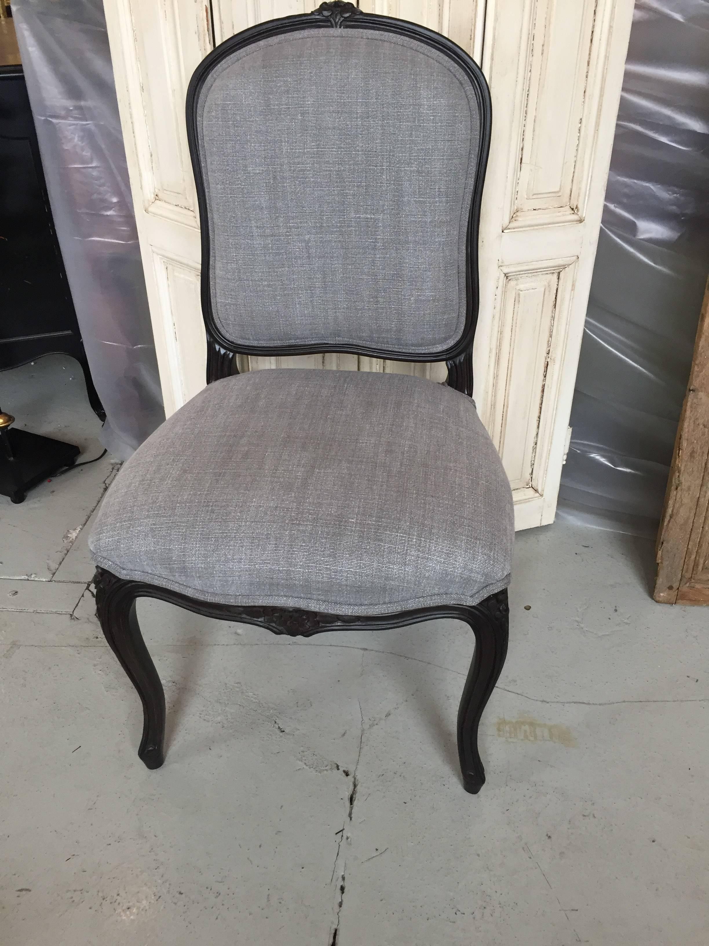 Set of eight Louis XV dining chairs painted ebony with gray Belgian linen backs and seats. Two of the chairs are corded in red velvet, six are self corded from a local French Design Shop in Paris.