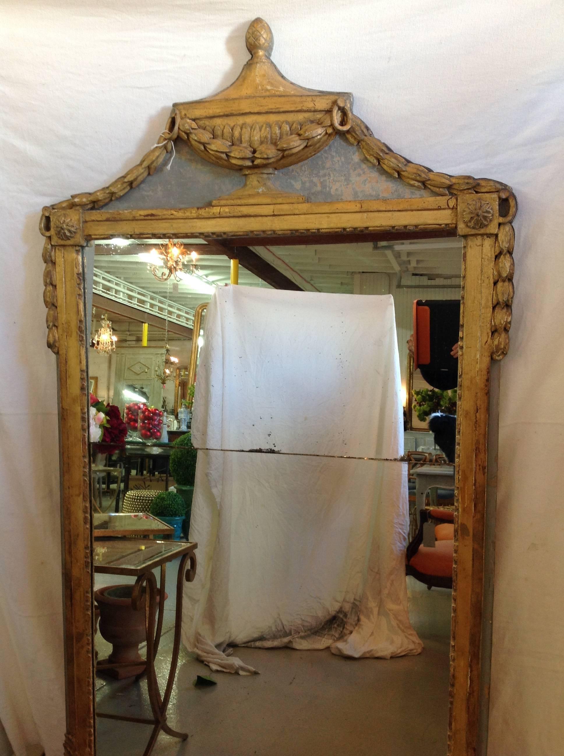 This mirror is exquisite and makes a statement with its fine carving and the wonderful gilt urn. Everything is original and comes from Normandy.