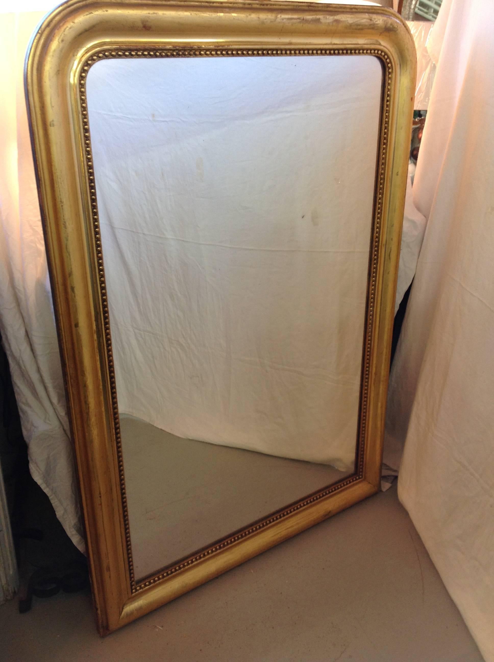 This beautiful gilt Louis Phillipe mirror purchased in France has lovely floral details and beading on the frame.