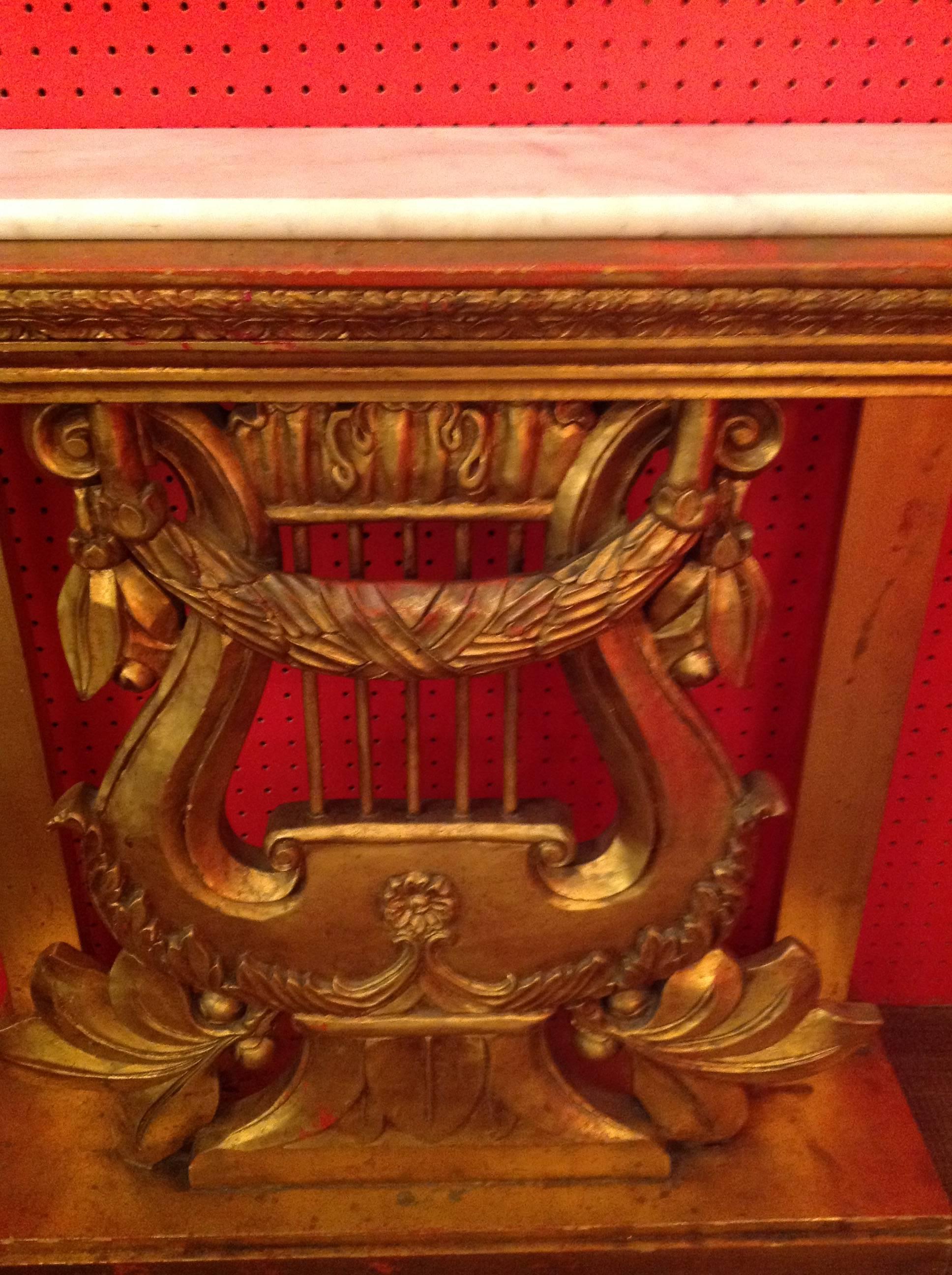 Vintage hand-carved gilt console table with harp base and statuary marble top.