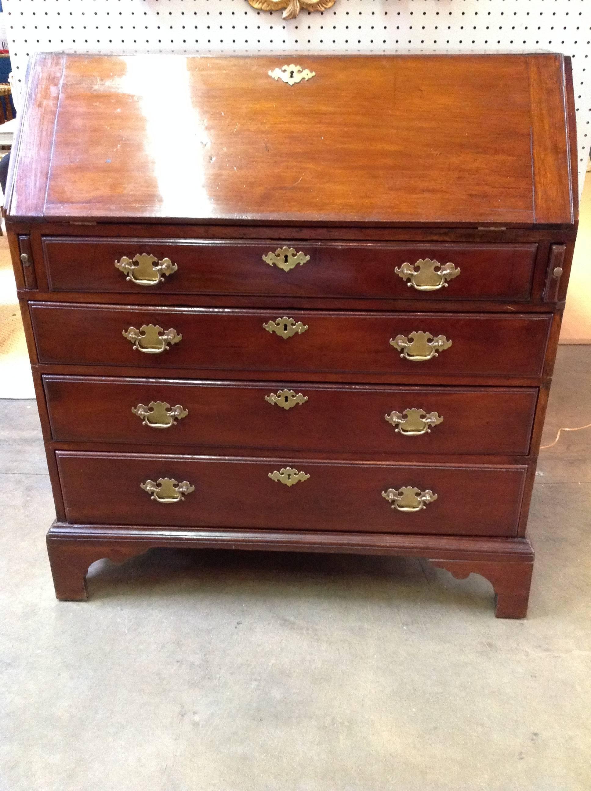 Four drawers with beautiful brass Hardware. We believe this was the bottom piece of a two-piece carcas. It is lovely and in great condition given its age.