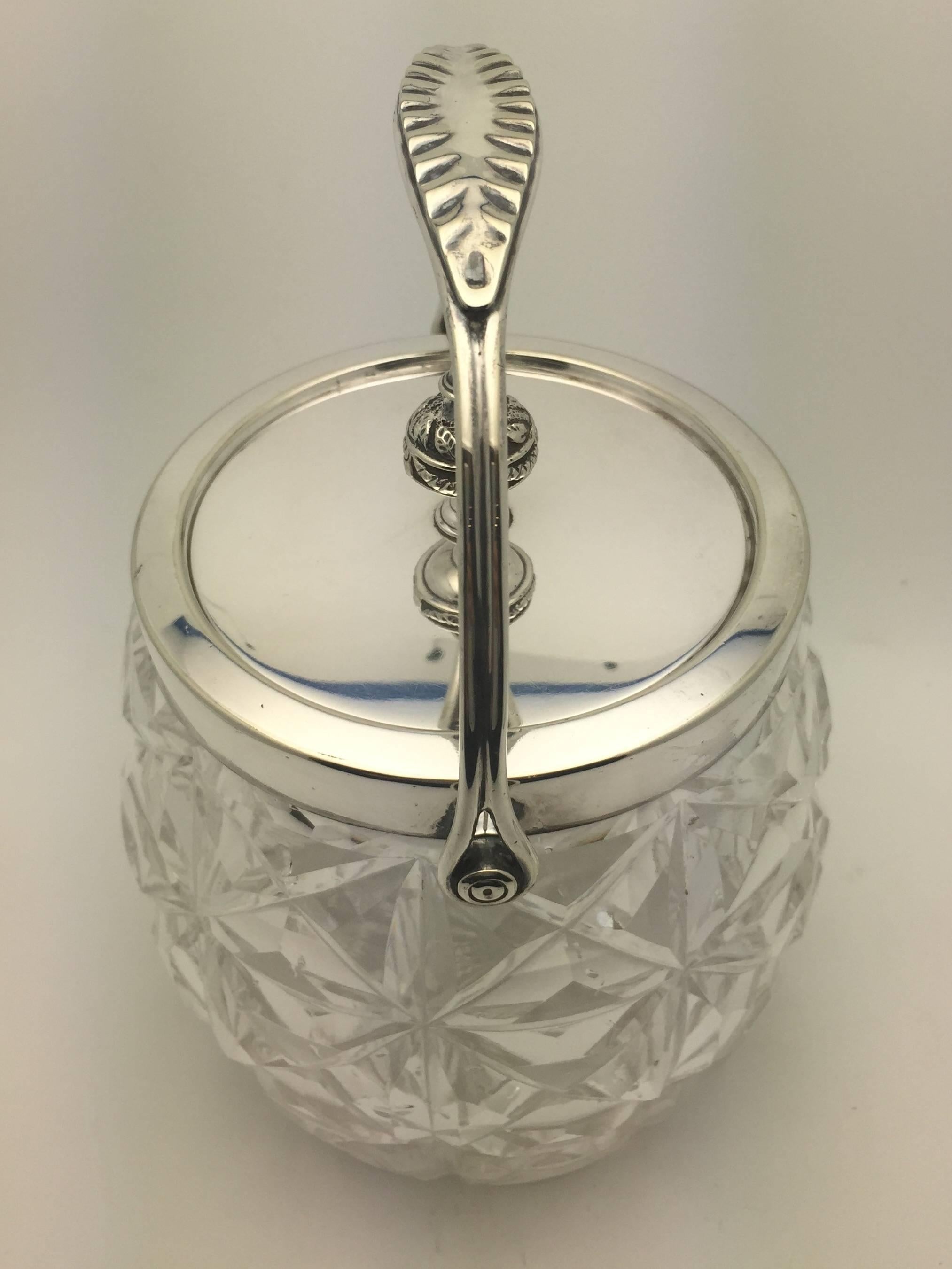 Cut-glass biscuit jar with silver plated mounts and swing handle by William Hutton & Sons.