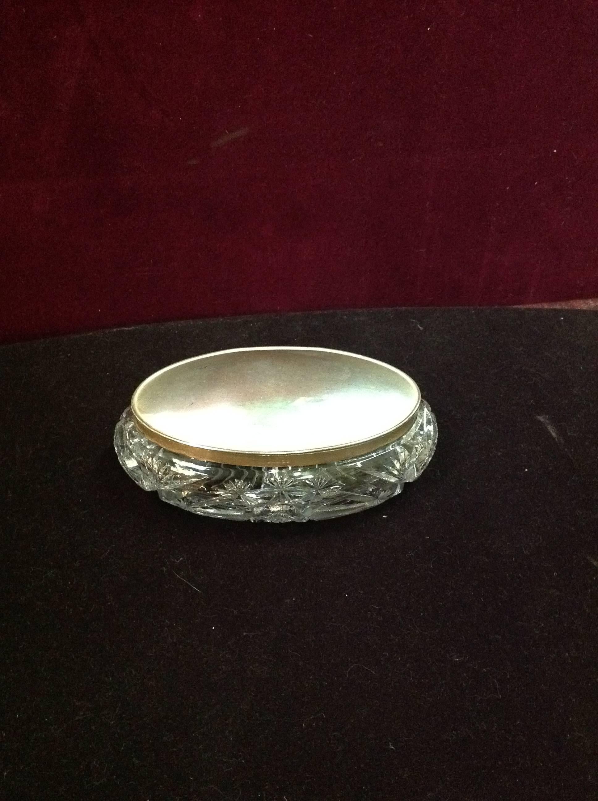This brilliant cut crystal box with sterling lid is from the early 1900s and marked Sterling.