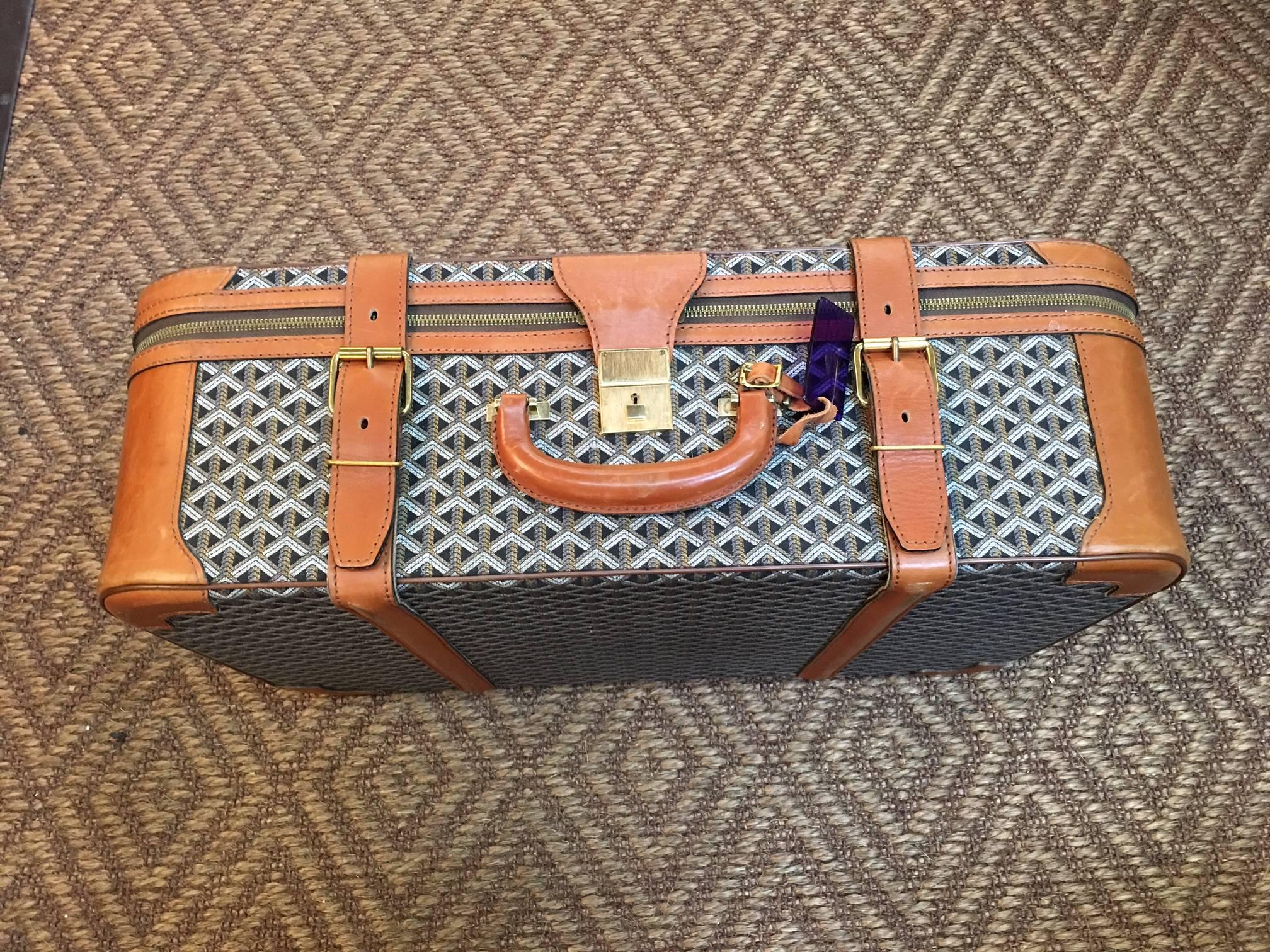 Large vintage Godard suitcase in great condition for its age. Missing its key and original tag but found with the original owners updated luggage tag from Switzerland.