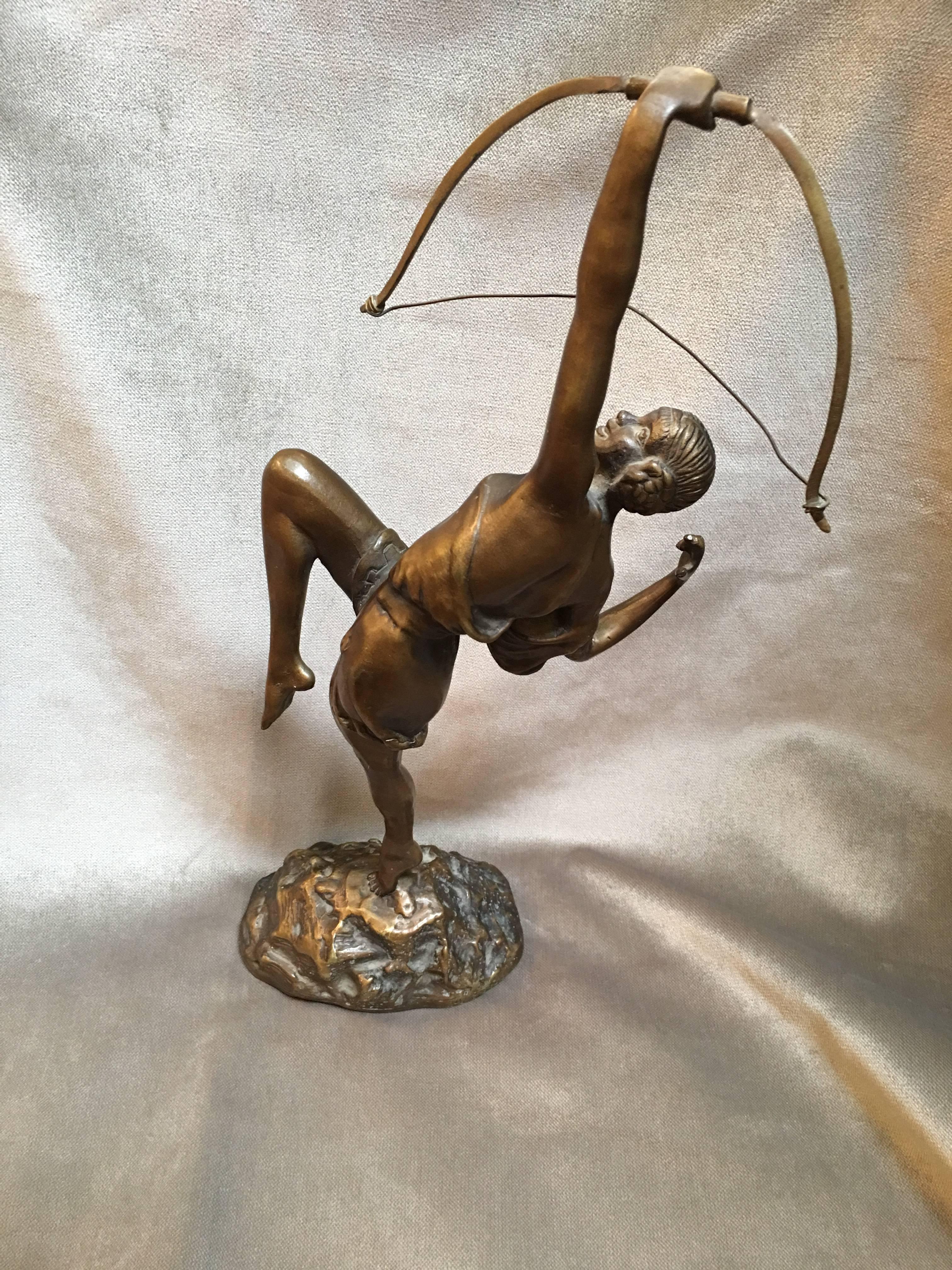 Designed by French sculptor Pierre Le Faguays, circa 1925, this Art Deco bronze statue features a young Grecian female Archer gracefully pulling her bow. The statue highlights exquisite detailing on a naturalistic base. The Sculpture is titled