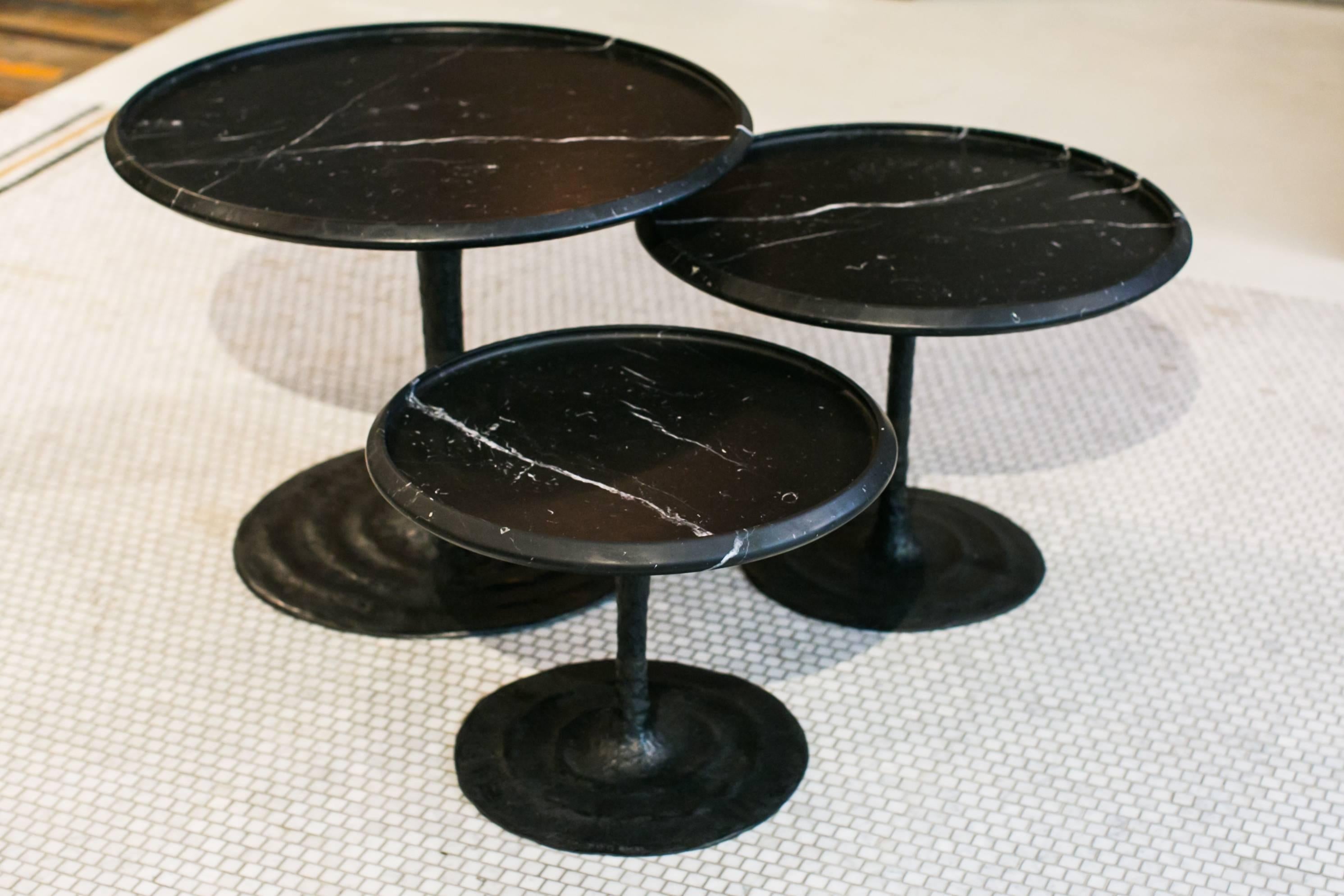 Limited edition, signed and numbered, the Giverny tables is a series of nesting coffee tables inspired by the nénuphars (waterlilies) of Monet's house in Giverny. The movement carved at the bronze foot evoke the water movement. Their elegant