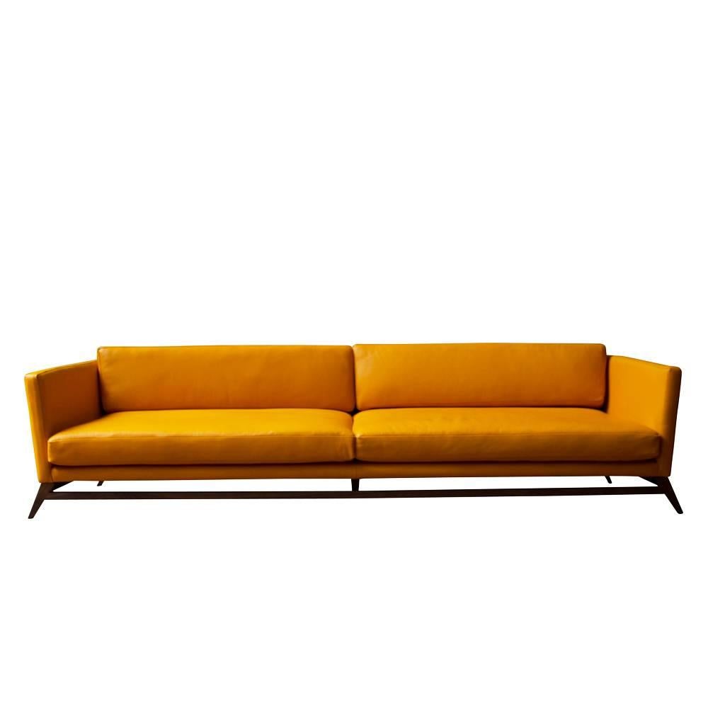 A luxuriously deep sofa that sits on a delicate solid wood leg configuration and low frame. It is an updated take on a Classic Mid-Century design. 

* Constructed using traditional joinery techniques
* Frame is made of solid wood in walnut,