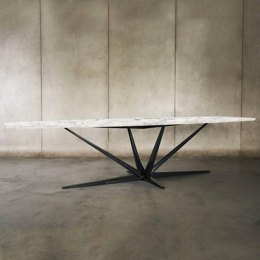 Designed by Alexander Andersson.

The Agave dining table is handcrafted and perfectly finished with a solid matte hardwood top as standard. The design has an elegantly tapered top with beveled edge and perches juxtaposed on a metal spiked base