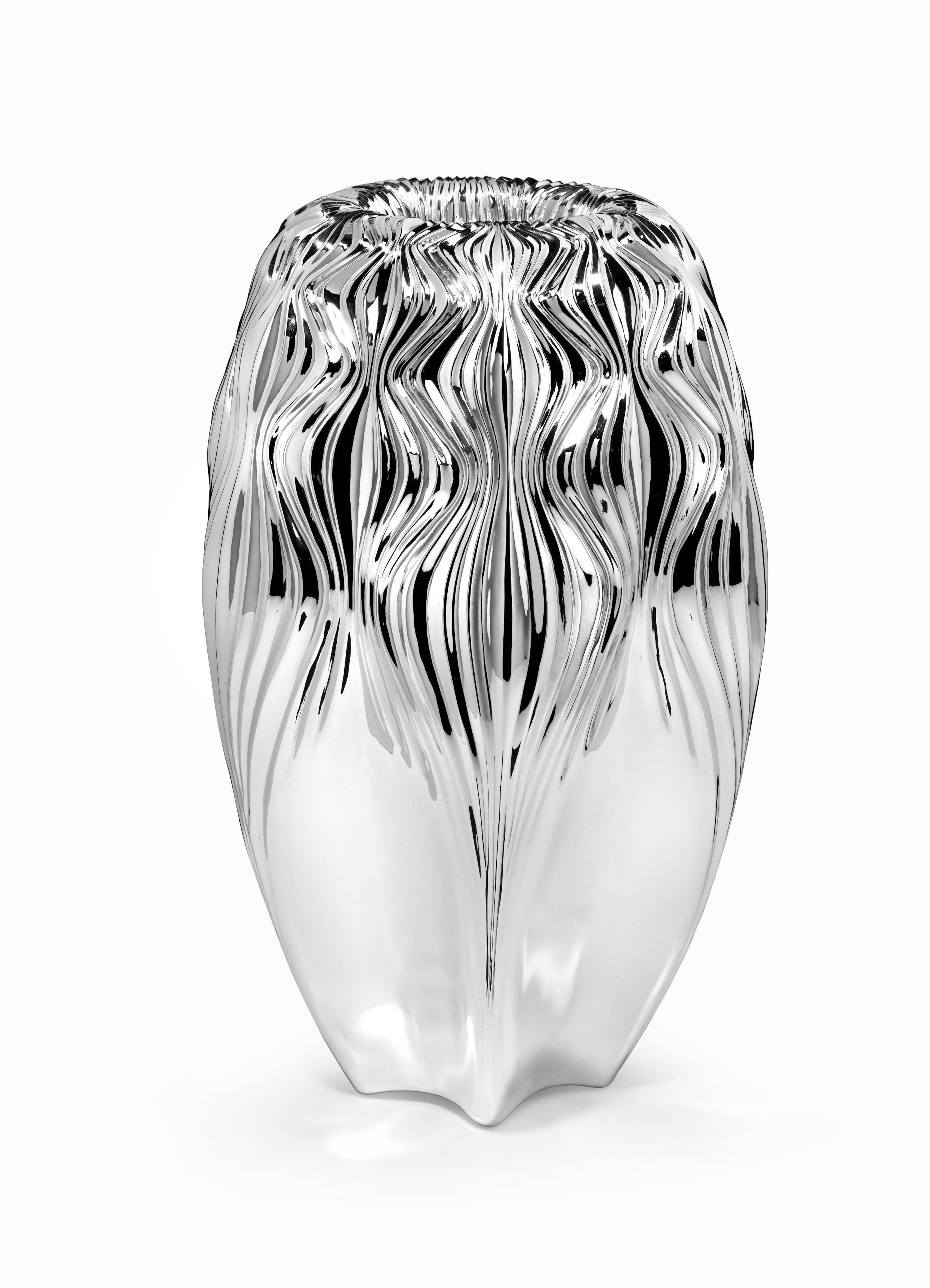 Traditionally handcrafted by the Viennese silversmiths, Zaha Hadid's two vases each express a powerful dynamic through their intricate surface complexity. The subtle fluctuations and distortions of ripples enveloping the surface are informed by