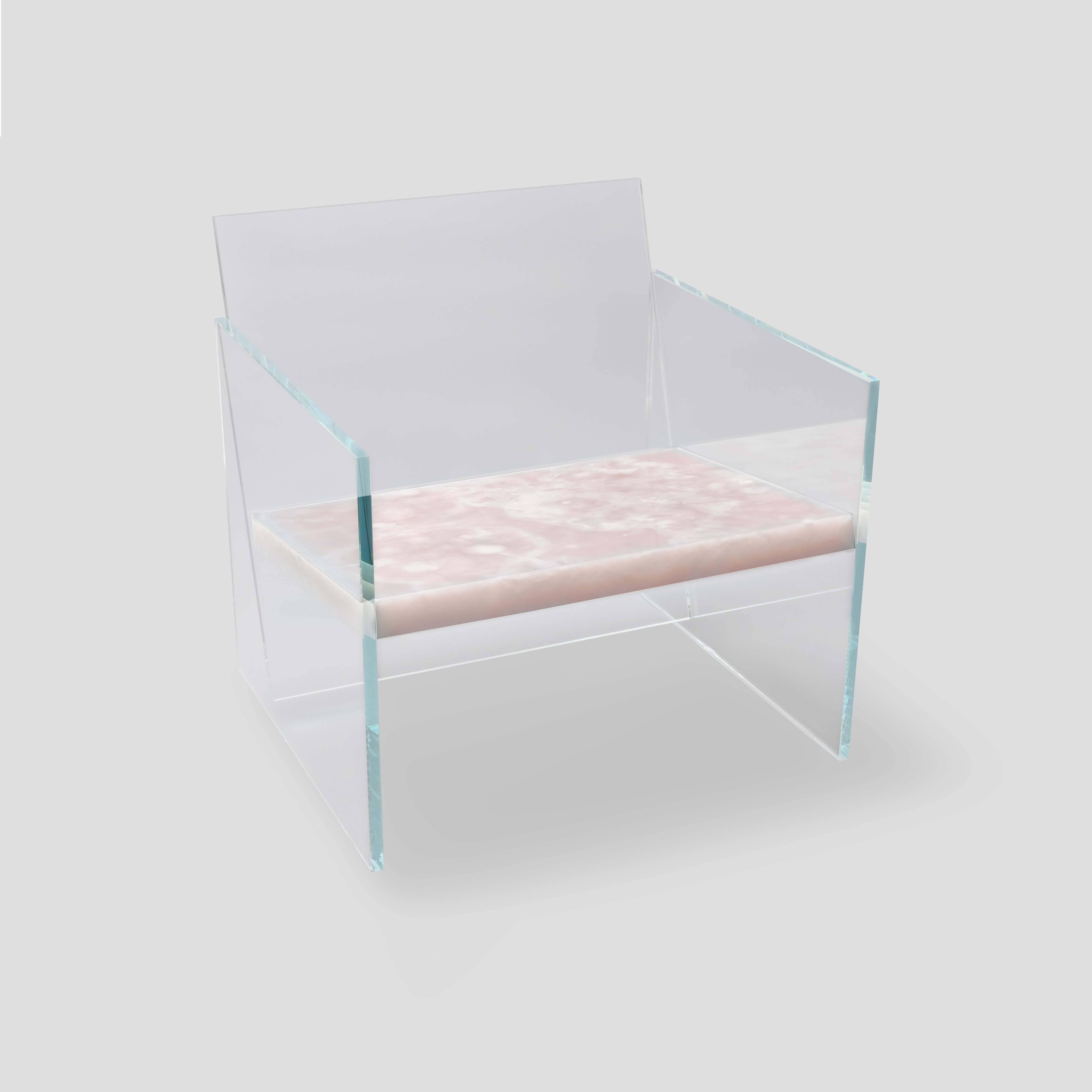 Characterized by its material and form, this lounge chair is made of ultra-clear glass and rose onyx; it is one of seven works from the Tension collection. Claste drew inspiration from the juxtaposition of stability and fragility to create this