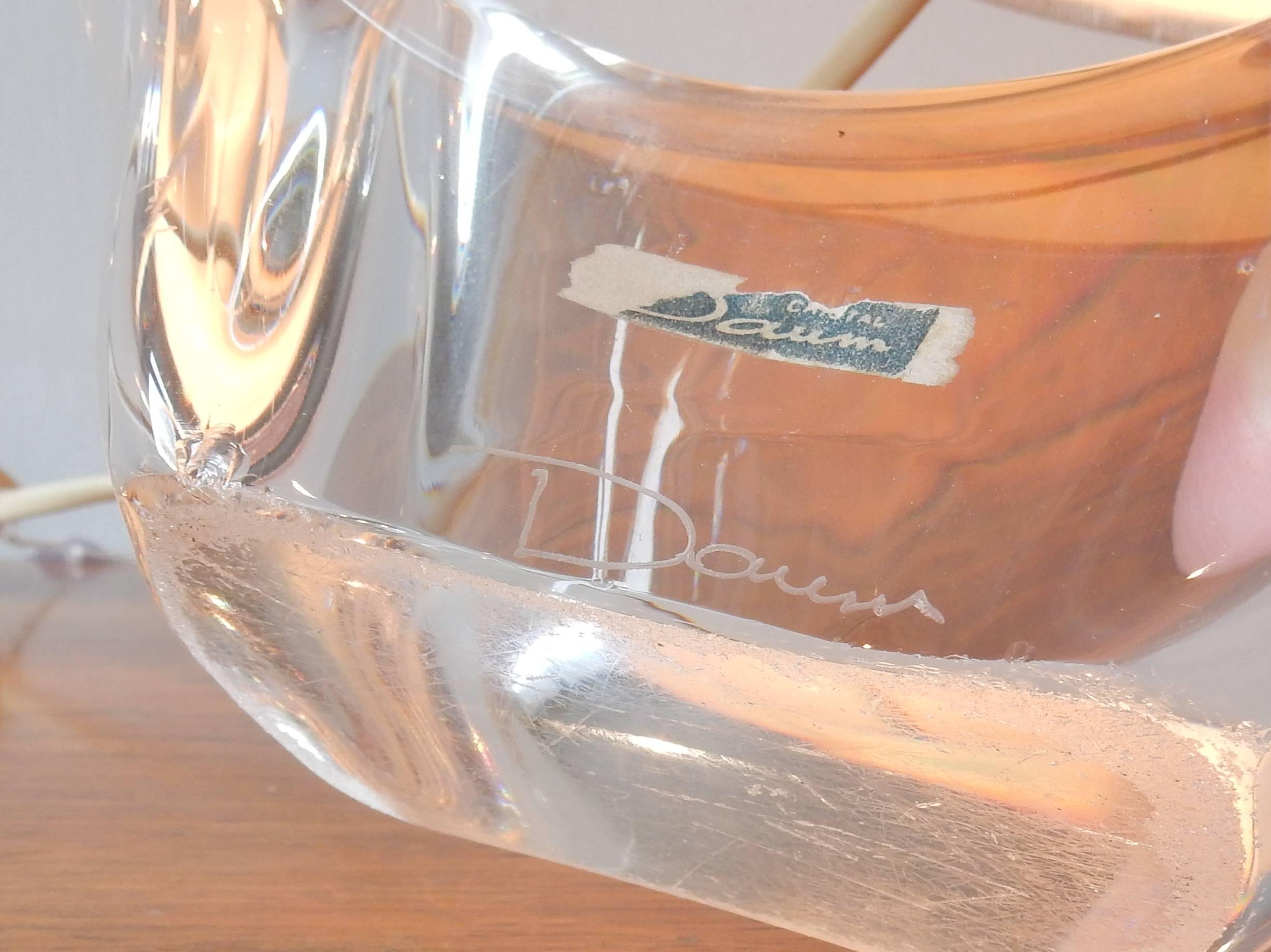 Tasteful table light of crystal glass by Daum from France. This lamp comes with the original sailboat shaped shade. The glass is signed and partial labeled. The bottom of the glass does show scratches from moving, also some minor chips to the edge
