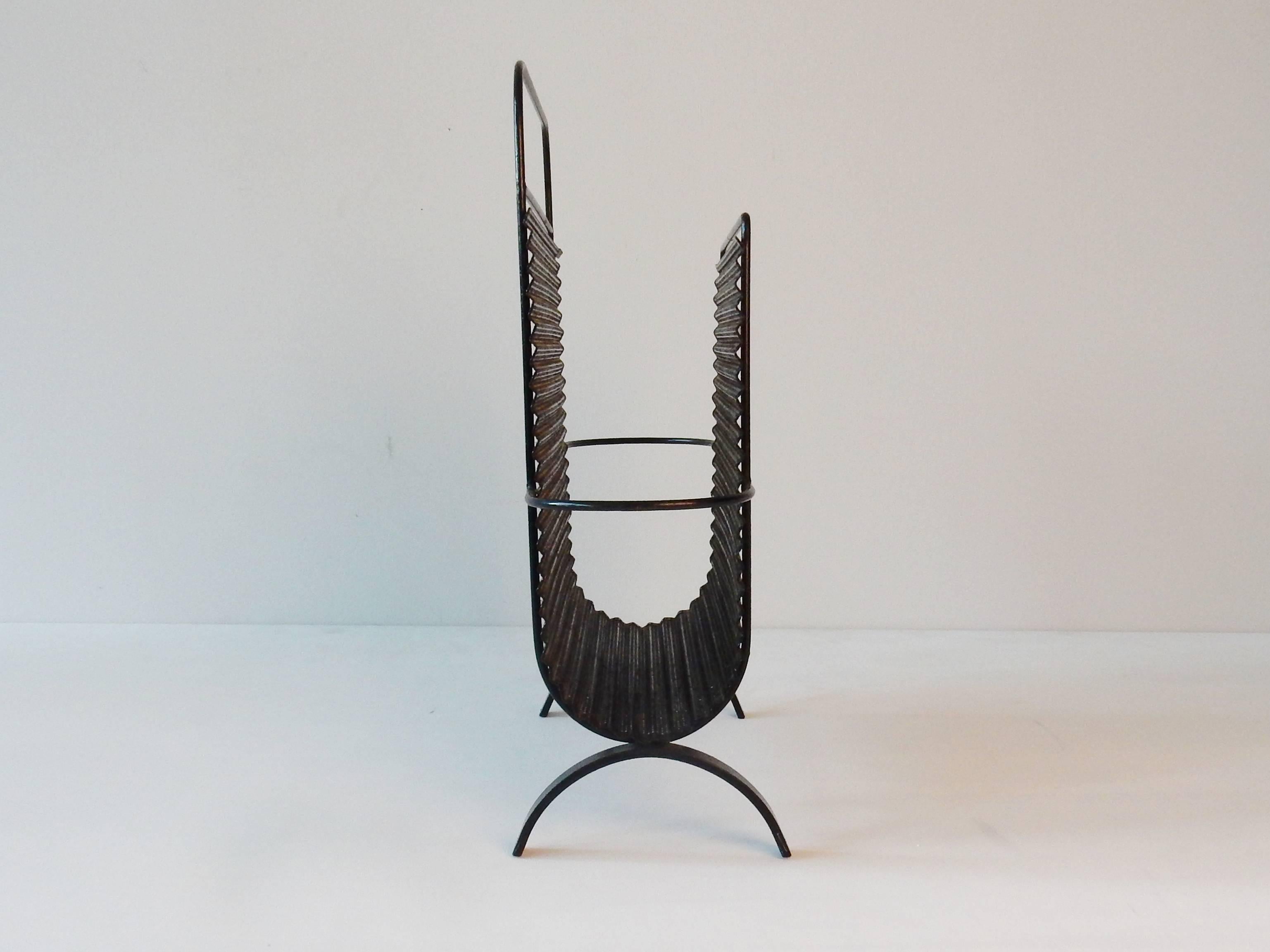 This magazine holder is a design by the famous Mathieu Matégot. The designs of Mategot are sought after worldwide. This magazine rack is in a close to perfect condition with an age of over a 60 years old.