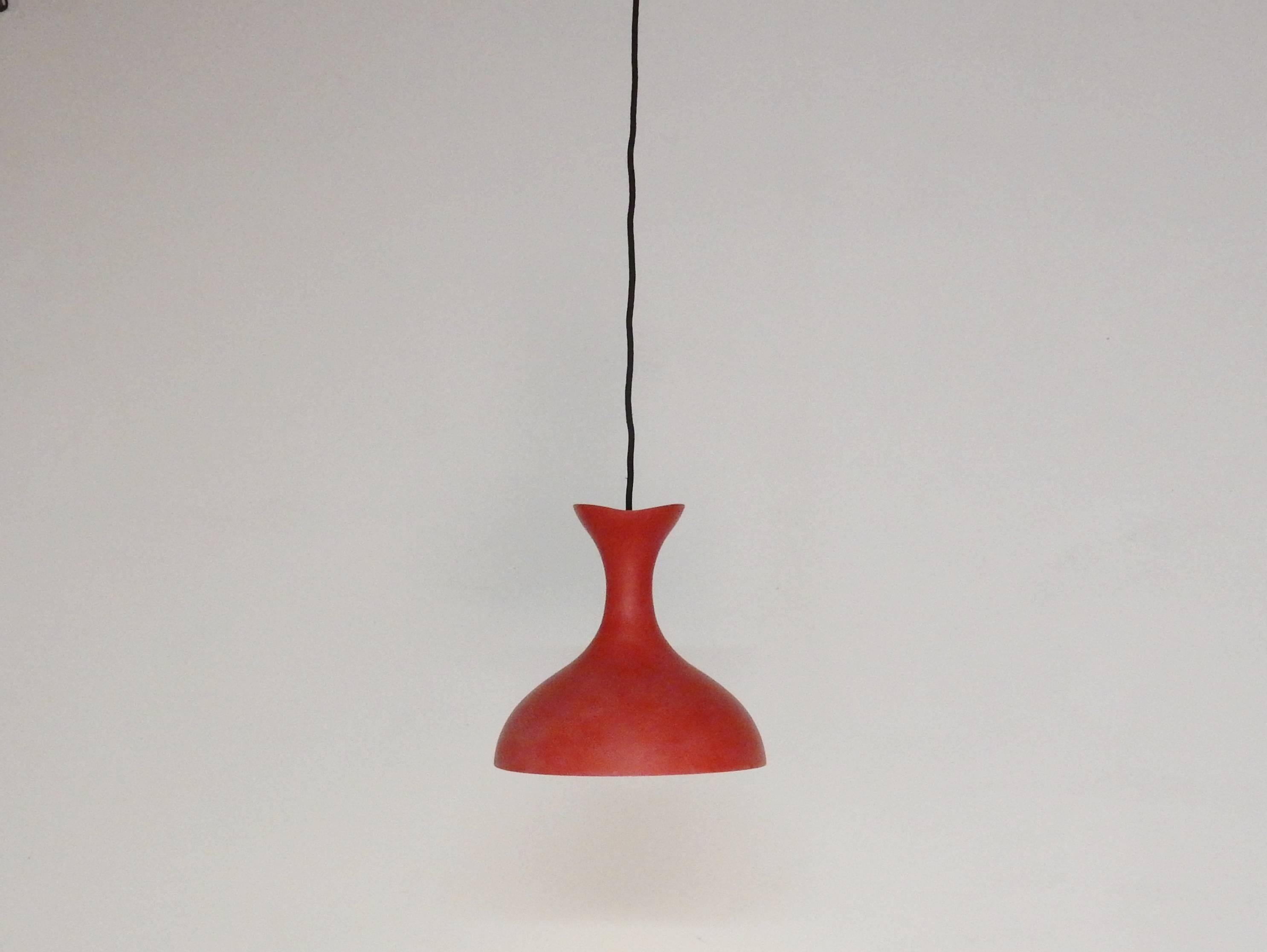 Very good looking red pendant light that we picked up in Denmark. The design and color could also make this light to be of Swedish origin, or maybe even Italian. The design reminds of, for example, designs by Svend Aage Holm Sørensen or Stilnovo.