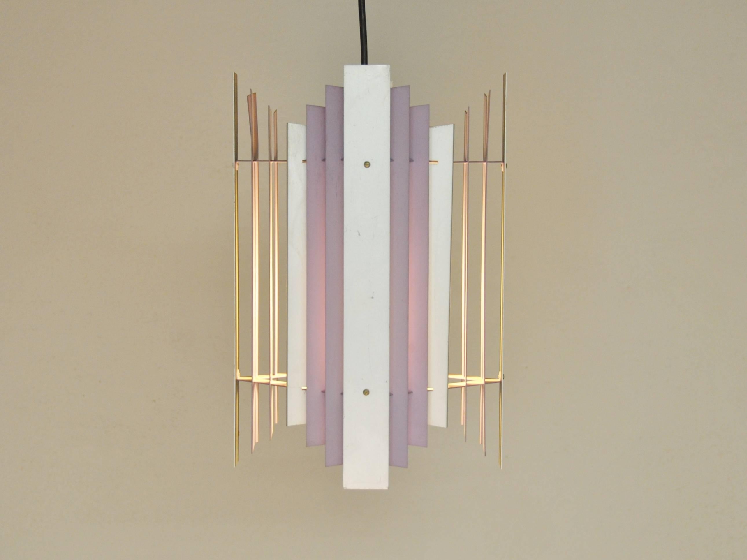 Very nice and rare pendant by Thue Christensen for Nordisk Solar. A design of metal plates in brushed metal and a soft lila in a very straightforward composition. This is a design from the 1960's and for that era this can be called a design that was