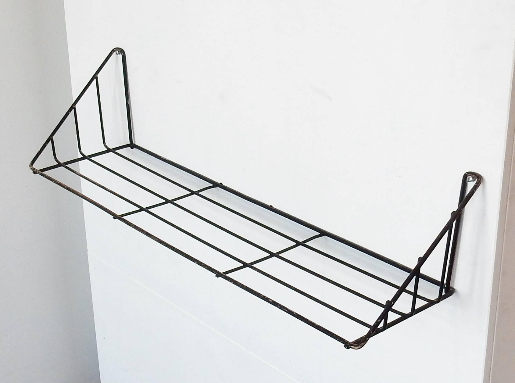 The 'Delft' wall shelves are of a design by Constant Nieuwenhuys for 'T Spectrum from 1956. A highly rare model wall shelve and we offer you a set of two. Both are in very good vintage condition and in their original colors, one black and one