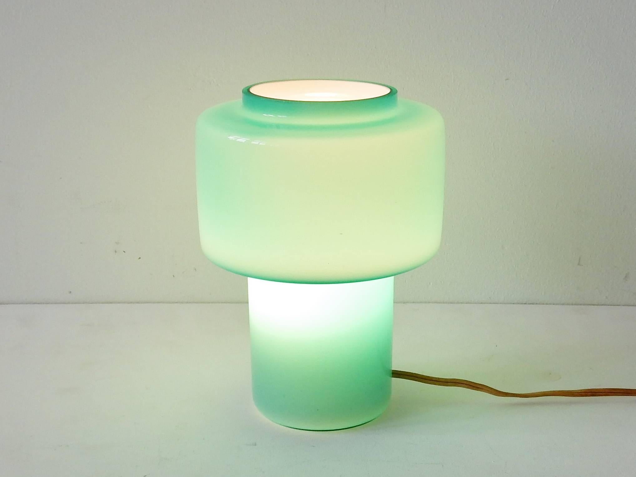 Very beautiful small glass table lamp in a good looking aquamarine or sea green color. This light is as beautiful on as when off. The inner white glass makes the soft color when lit. 
The condition of this light is very good with very little signs